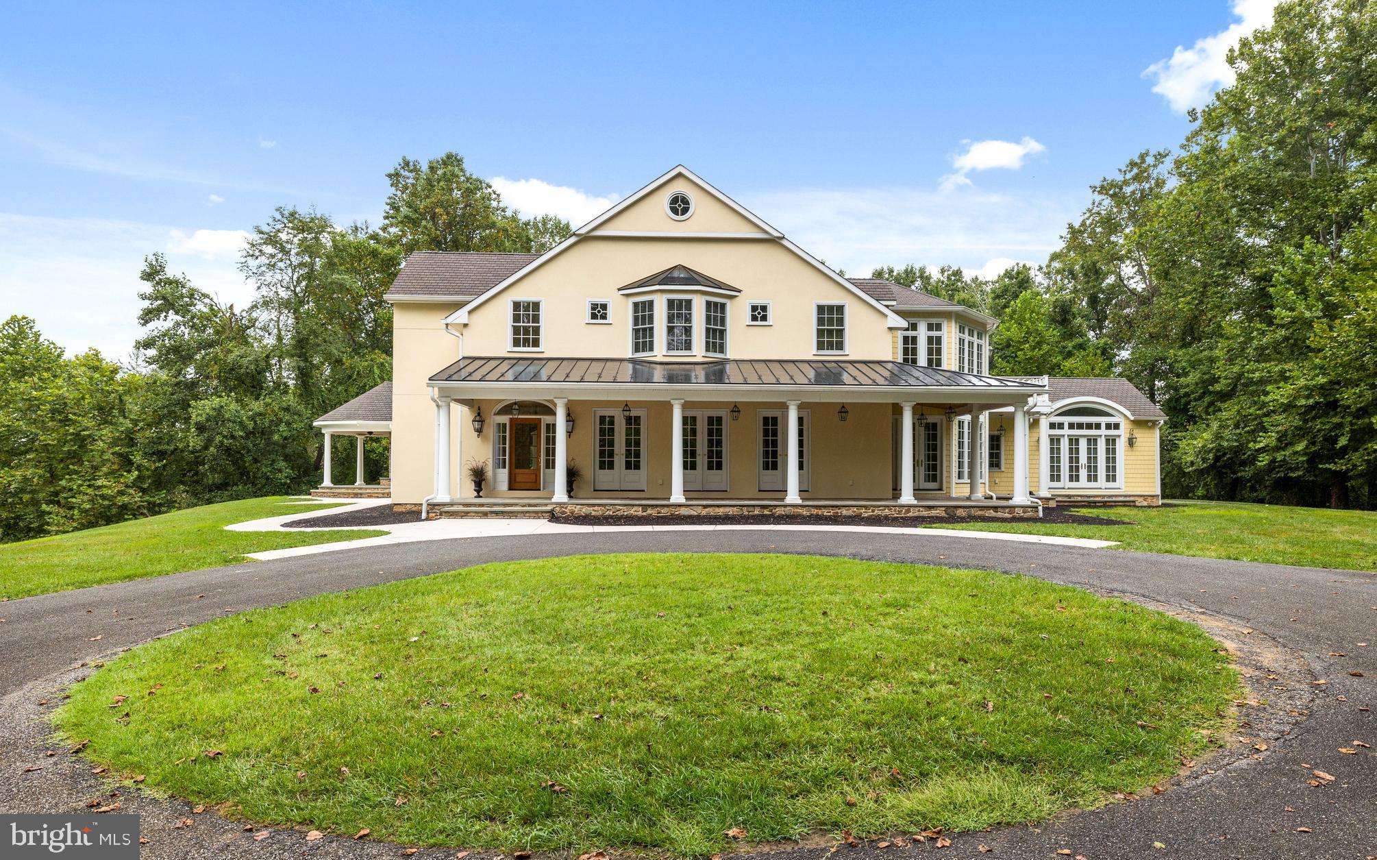 New Price...Tucked away at the end of a long  driveway  sits a custom built Colonial on 12+ private wooded acres.  Step up onto the covered bluestone front porch and enter into the gracious  2 story foyer - No detail was overlooked with over sized  moldings, custom built-ins, updated light fixtures and hardwood floors through out. The Living has a wb fireplace flanked by custom bookcases and a secret door leading to the library/study.  The large Great Room with its raised stone (wood burning) fireplace, vaulted ceilings, recessed lighting,  opens to a magnificent Gourmet Kitchen and Dining area. Enjoy a true Cooks' Kitchen with a breathtaking  center island, custom counter-to-ceiling cabinetry & professional grade appliances including: a paneled  Sub Zero Refrigerator & a paneled Sub Zero Freezer, Wolf 36" 6 Burner dual fuel Range, microwave, warming drawer & a beverage refrigerator, double sinks, 2 walk in pantries & Butler's pantry  off the kitchen & Dining room makes this house designed for entertaining.  The Main Level Primary Suite has a beautiful light filled sitting room, spacious bath with sunken tub, shower and double vanities plus a fabulous walk in closet . Also, on the main level is the laundry - mudroom and 2 powder rooms. The Upper Level has 3 large bedrooms. Bedroom # 2 has a large custom closet & ensuite bathroom. Bedrooms #3 & #4 share a Jack & Jill Bathroom.  Plenty of storage on the 2nd level plus another laundry room.  The lower level leads you to a huge family room  with fireplace,  a  media room waiting for finishing touches, full bath and  utility area.  A plethora of windows allows for spectacular views and an abundance of natural light all year round. There's a side covered bluestone porch with a raised fireplace off the Great Room.  Perfectly located to the rear of the house  is the 3 car oversized detached Garage with  epoxy flooring and a unfinished 2nd level. If you love nature walk to the NCR Trail & Gunpowder River. Welcome Home!