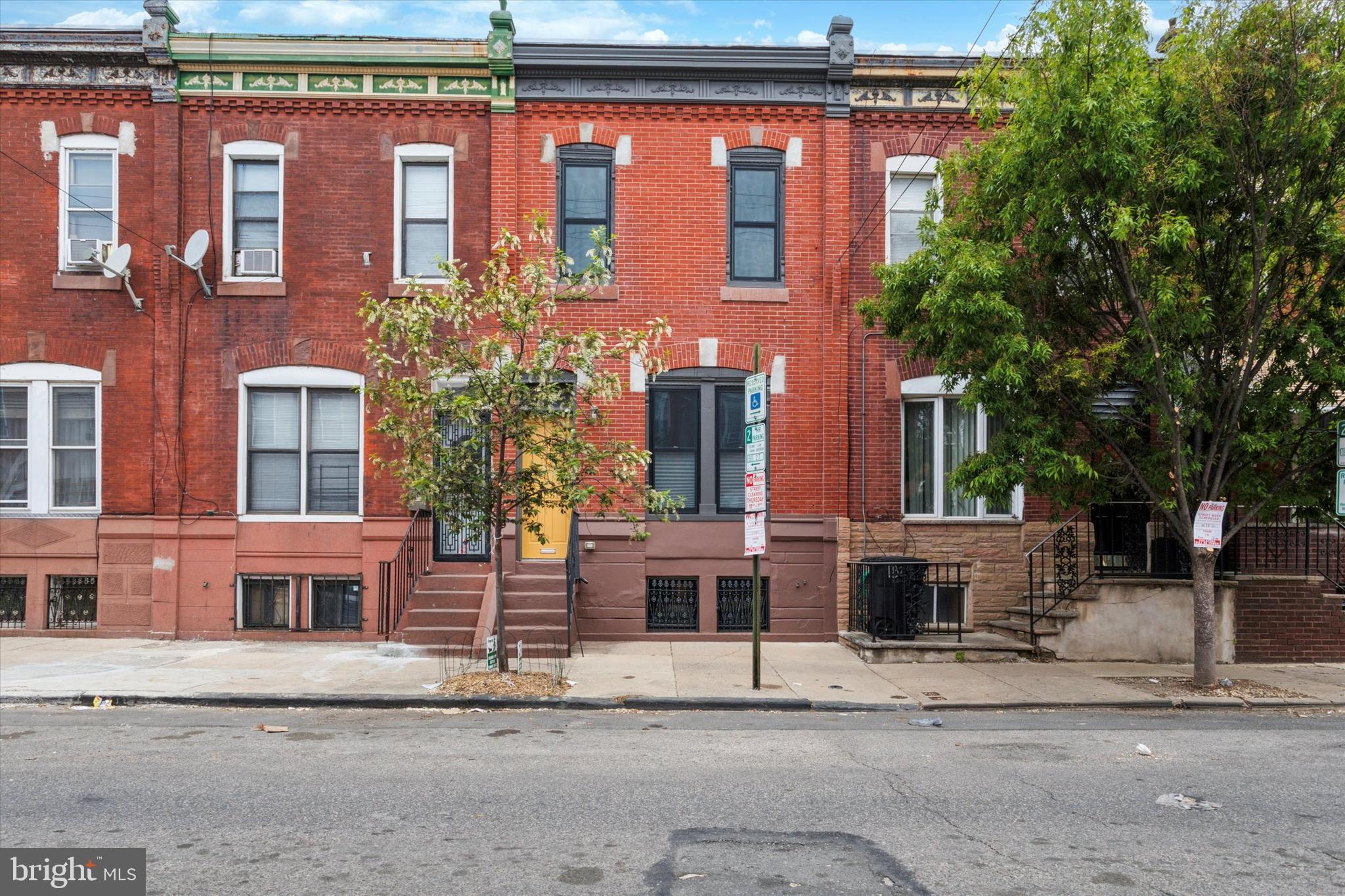 A total dreamboat inside and out, this renovated Point Breeze rowhome is anything but cookie-cutter. The handsome facade has detailed brickwork, a stately cornice and a transom window above the front door, which gives way to a vestibule entrance with original slate tile walls and a main floor with original pine floors that run throughout, super high ceilings and great natural light. The spacious open living/dining room features ceramic Schoolhouse Electric light fixtures and the original staircase with lovely wood banister. The kitchen has an enormous amount of storage space via contemporary Ultracraft white and maple drawers and cabinets that extend to the ceiling, as does the open shelving above the fridge. A salvaged beadboard backsplash and Caesarstone countertops are carried through to the breakfast bar island, which has fun electric blue Muuto pendant lights with quilted LED bulbs and an oversized zero-radius Miseno stainless steel undermount sink with Grohe pulldown faucet. Stainless steel appliances include a Whirlpool five-burner range, dishwasher and microwave, and a Haier French door fridge. This space is nice and bright due to two windows plus a glass door to the downright huge rear yard, which consists of both a large patio and garden bed, plus a bonus side area to stash away bikes, trash cans and gardening supplies. Tucked between the main living space and the kitchen is a powder room with more salvaged beadboard wainscoting, Grohe fixtures and an awesome vintage Beaty American light fixture. The second floor has ample natural light like the first floor, as well as high ceilings and wide-plank original pine floors. The large rear bedroom has two exposures and a nice view of the yard. The middle bedroom has both a standard closet and a second one outfitted with shelves. The spacious primary bedroom at the front gets great southern light and has a big closet and a charming architectural niche. The super stylish hall bath has a full-wall oversized subway tile surround for the Miseno tub with Grohe fixtures and Caesarstone bench seat; the most fun Noga blue and white Moroccan mosaic cement tile floor; and a stylish wall-mounted sink flanked by sconce lighting. There’s storage space and laundry in the full basement. This nice and wide Point Breeze street is just a couple blocks from neighborhood favorites Ultimo Coffee, Hardena cafe and South Philly Taproom, and convenient to tons more dining on nearby Snyder and Passyunk aves.  And as a bonus, there's still plenty of time left on the tax abatement.