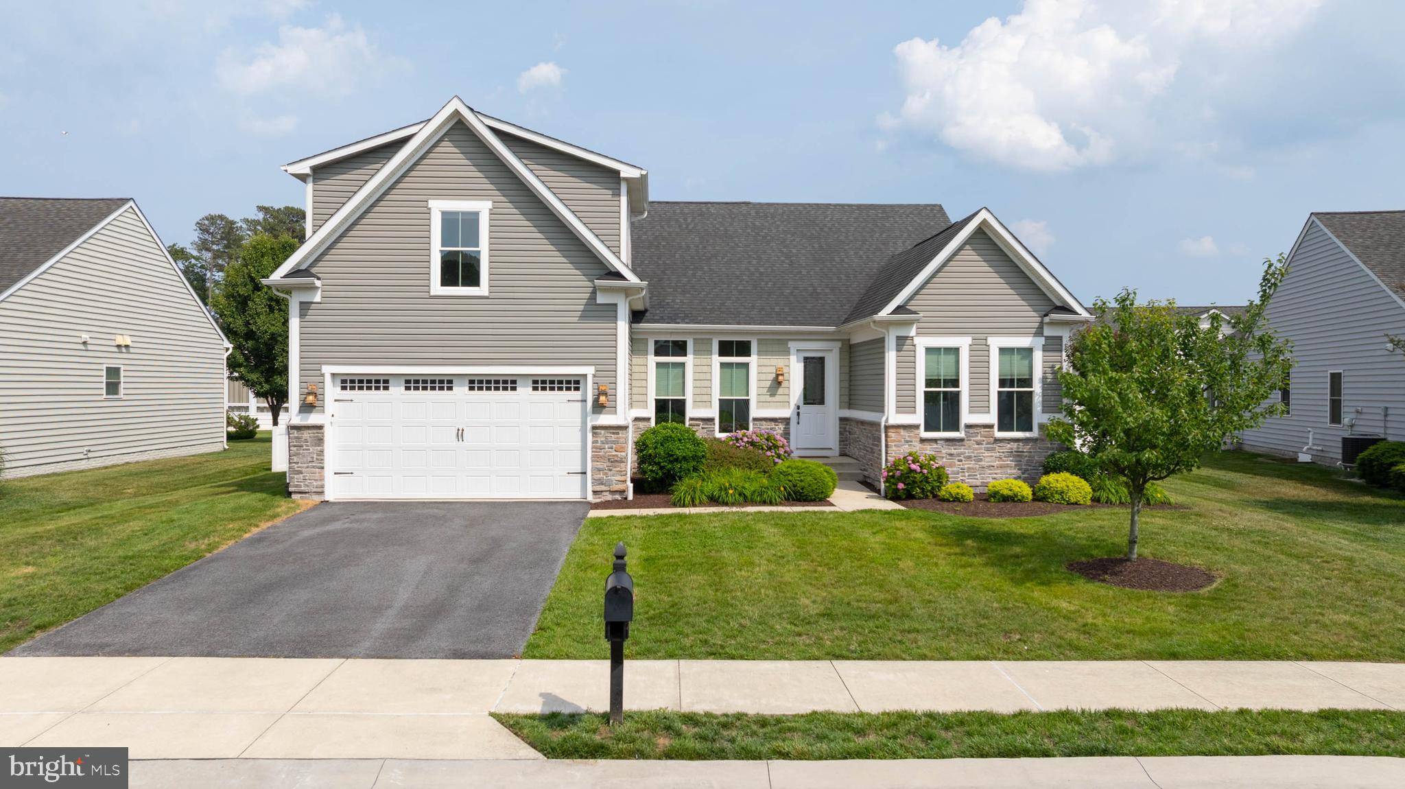 Perfectly positioned east of Route 1 and just minutes from downtown Rehoboth Beach, this beautifully appointed home offers the ideal combination of space, comfort, and convenience in one of the area's most sought-after communities.

Step inside to a welcoming foyer that opens to a bright, airy floor plan . Natural light pours through oversized windows, illuminating the spacious great room, formal dining area, and kitchen. At the heart of the home, the kitchen features granite countertops, an oversized island with counter-height seating, and a sunny morning room that creates the perfect gathering place for casual breakfasts, holiday celebrations, and everything in between.

The first-floor master bedroom provides  privacy and convenience, while upstairs, an additional guest bedroom, a full bath, and an expansive bonus room ensure plenty of space for family and friends to feel right at home. Just beyond the main living area, a porch invites you to relax and unwind while overlooking mature trees and one of the larger homesites in the community. 

Life at The Grande at Canal Pointe is about more than just the home. Residents enjoy lawn maintenance, two community pools, tennis and basketball courts, a playground, scenic walking paths, and a canal-front park with kayak and paddleboard access to the Rehoboth-Lewes Canal. The Junction & Breakwater Trail is just outside the community entrance, offering miles of biking, walking, and running between Rehoboth Beach and historic Lewes.

Located approximately 2.2 miles from Rehoboth Beach's boardwalk, beaches, boutiques, and award-winning restaurants, this home places you at the center of Delaware's coastal lifestyle while still providing the privacy and tranquility of a well-established community.

From morning bike rides to sunset dinners, this is the coastal lifestyle you've been waiting for.