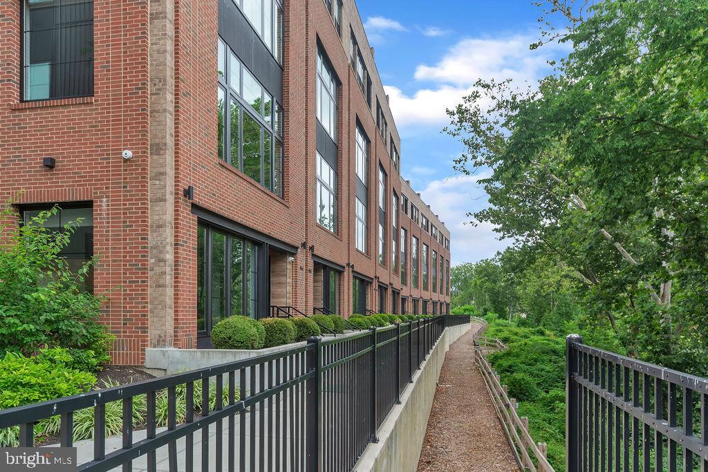 Stroll to dinner on Main Street, walk the historic Manayunk Canal Path, take the nearby train in to the City or catch a gorgeous sunset from the private roof deck of this impeccable home in the riverside community of The Locks in Manayunk!  Complete with high-end luxury upgrades, this 4 bedroom 3.5 bath home comes with 5-STOP ELEVATOR and SMART HOME technology (over $100k cost in smart features), 2-CAR garage, aforementioned ROOF DECK and AMAZING RIVER VIEWS.  You are welcomed inside, where you will find a wonderful flex room, with river views, that can be used as a study, family room, gym or playroom.  This room provides easy access to the garage.  Head up a flight of stairs or take the convenient elevator, to the main living floor, and you are immediately struck by the  exquisite finishes, the floor to ceiling windows which allow incredible natural light and a functional open floor plan, perfect for everyday living and/or entertaining family and friends.  The gourmet kitchen will delight the home chef and features stainless steel appliances, a 6 burner range and a spacious center island with quartzite counter.  It also boasts a pantry and lovely breakfast area.  The dining room is open to the kitchen and living room.  The living room has a fireplace and breathtaking views of the river.  You  feel as though you can "touch" the water.  A powder room completes this level.  The third level features a large bedroom overlooking the river and full ensuite bath.  There is another generously sized bedroom, hall bath and laundry on this level.  The fourth floor serves as the luxurious owners suite with primary bedroom, a spacious walk in closet with built-ins,  and a private balcony with river views.  The expansive bathroom offers dual vanities and  a walk-in marble shower.  There is a beverage station, as well as a 4th bedroom, that could be used as sitting room,  office or nursery.  The piece de resistance is the roof deck with IPE decking.  Here you can delight in the river views and views of Manayunk and surrounding areas and enjoy outdoor gatherings and relaxation.  The fully equipped smart home includes alarm system, door locks, intercom, surveillance cameras, heating, lighting, high quality sound system, blinds, smart TV controls and elevator.  There are a little over 6 years remaining on the tax abatement.  This exceptional home is well priced for the incredible river views, ultra-convenient location and all of the upgrades.  Don't miss this spectacular home and amazing opportunity.