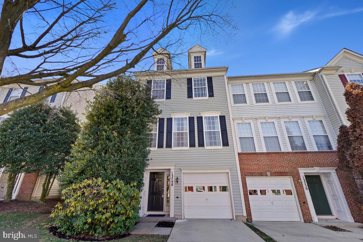 Open house canceled. Welcome to 13748 Dunbar Terrace in the desirable Kingsview Village community! This spacious end-unit townhome offers over 2,200 square feet of living space across 3 finished levels.

As you enter the home, you are greeted with a lower-level entry featuring garage access and a large family room boasting a cozy gas fireplace and built-in shelving. This level also includes a convenient dedicated laundry area.

The open concept main level showcases gleaming wood flooring throughout, creating a warm and inviting atmosphere. The living room is bathed in natural light from numerous windows, while the dining room features beautiful wainscoting trim detail.

The gourmet eat-in kitchen has an island featuring breakfast bar seating, ample cabinetry, and direct access to the large back deck. The deck overlooks the lush treelined conservation area, providing the perfect backdrop for outdoor entertaining and enjoyment.

Upstairs, the bedroom level boasts a primary suite with a vaulted ceiling, walk-in closet, and an ensuite bath upgraded with a soaking tub, double sink vanity, and a walk-in glass and tile shower. The secondary bedrooms share a full bath, providing comfort and convenience for family and guests.

Enjoy the convenience of new carpet throughout the home. The Kingsview Village community offers a range of amenities including a swimming pool, walking paths, and playground ensuring a vibrant and active lifestyle for residents.

Located just minutes from shopping, restaurants, local parks, and schools. Easy access to major transportation routes including I-270, 355, and public transit options. Marc Train station less than 1 mile away! Don't miss out on this incredible opportunity to make this stunning townhome your own!
