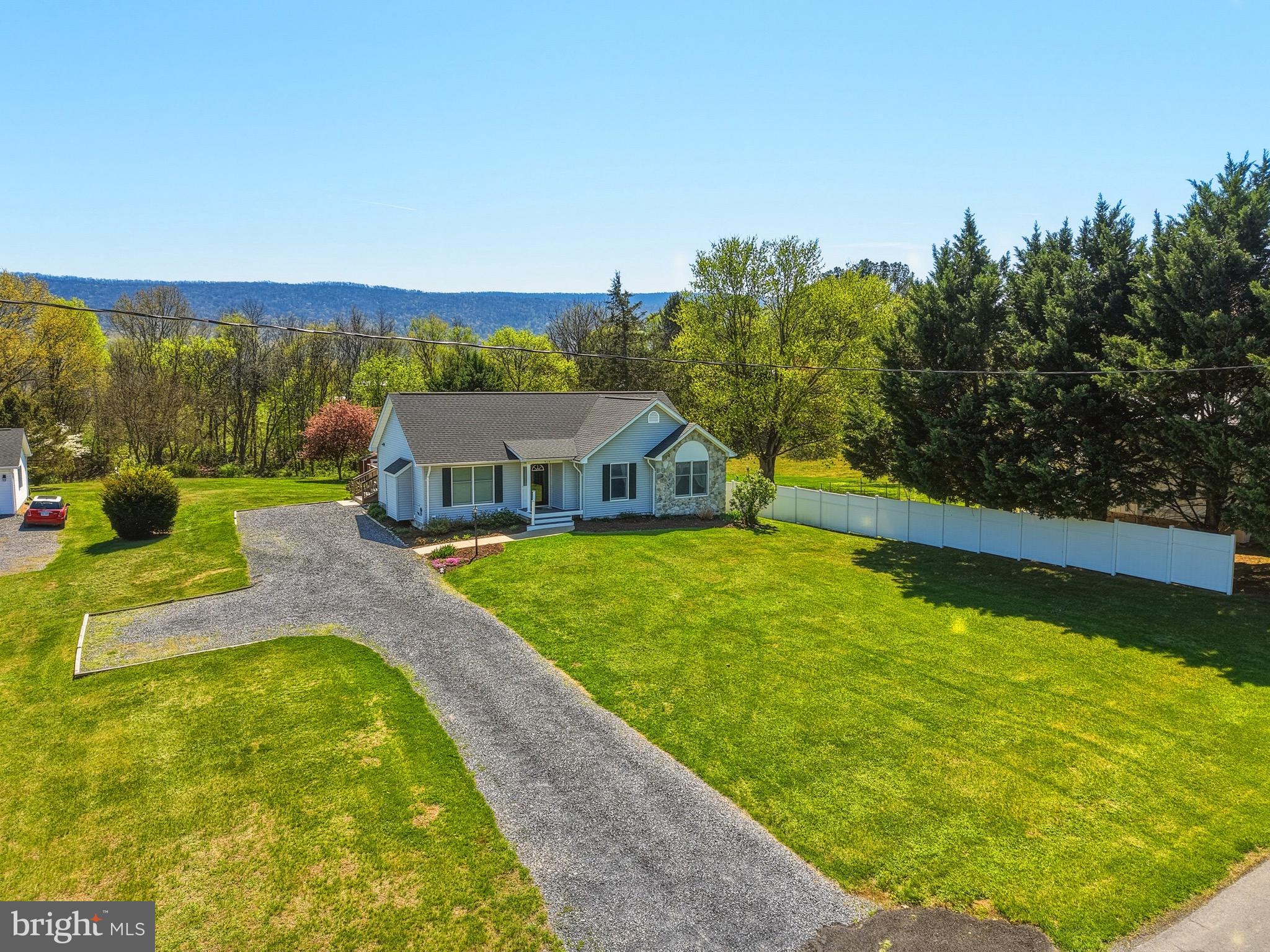 Welcome home to this beautifully maintained ranch offering charm, comfort, and stunning mountain views! From the moment you arrive, you’ll be drawn in by the eye-catching stone front accent, freshly mulched landscaping, and vibrant flowers beginning to bloom—creating the perfect first impression.  A new roof installed in 2024 adds even more value and peace of mind.

Step onto the inviting covered front porch and into a bright and welcoming living room featuring a cozy gas fireplace, perfect for relaxing evenings. Large windows fill the space with natural light, and the open layout flows seamlessly into the dining area and kitchen. The kitchen offers solid wood cabinetry, ample storage, and a recently updated dishwasher, making it both functional and inviting.

Just off the dining area, you’ll find a beautiful enclosed sun porch—an ideal spot to unwind while taking in peaceful mountain and backyard views. Step outside to the rear deck, perfect for entertaining, grilling, or simply enjoying the outdoors.

The main level also features a convenient laundry area, two comfortable guest bedrooms, a full bathroom, and a spacious primary suite. The primary bedroom includes two closets, one being a large walk-in, and an attached bath complete with a double vanity, soaking tub, and walk-in shower.

The walk-out lower level expands your living space with a large family room, an additional room perfect for a home office or guest space, a half bath, and a generous storage area.

Outside, enjoy a spacious backyard complete with a storage shed and plenty of room to relax or play. The driveway offers ample parking for guests and everyday convenience. 

This home truly combines comfort, functionality, and scenic beauty—don’t miss your opportunity to make it yours!