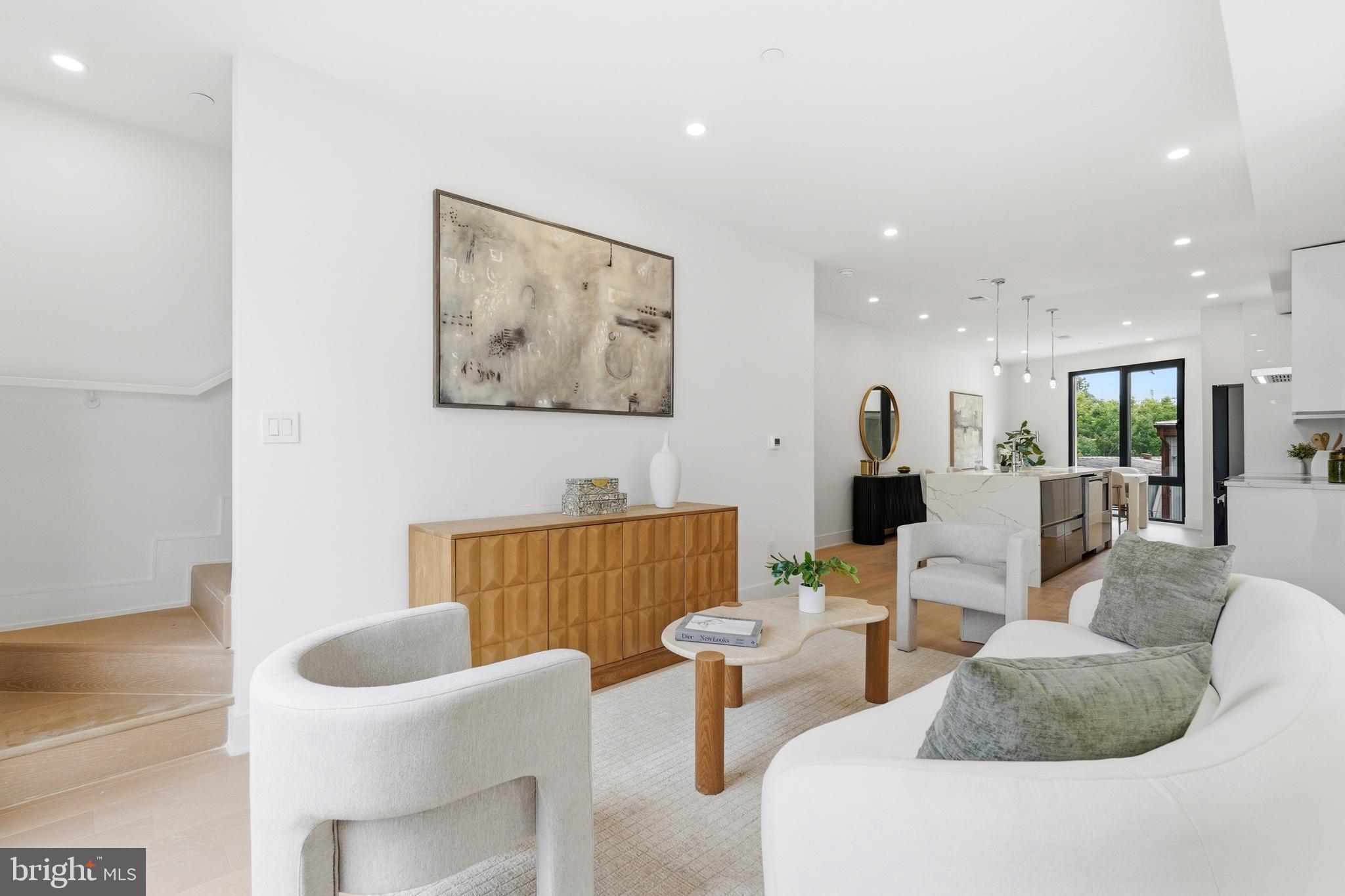 Set atop a boutique new development in Ivy City, this two-level penthouse delivers over 2,000 square feet of refined, design-forward living. With 4 bedrooms, a den, and 4.5 baths, the layout offers both scale and flexibility, ideal for modern city living.

The main level unfolds into a bright, open living and dining space centered around a streamlined kitchen with bold cabinetry, a statement island, and clean architectural lines. Wide-plank oak flooring grounds the space, while high-performance European windows provide both quiet and abundant natural light throughout.

Upstairs, the bedroom suites are well-separated for privacy, each paired with its own bath and finished with elevated materials. The additional den creates an ideal work-from-home setup or secondary lounge.

Above it all, a private rooftop terrace offers a true extension of the home—generous in size and positioned to capture iconic city views, making it equally suited for entertaining or quiet evenings.

Off-street parking included and a thoughtfully designed modern building complete the offering. Ideally positioned near Union Market, Ivy City, and the National Arboretum, residents enjoy easy access to acclaimed restaurants, breweries, cafés, fitness studios, and some of DC’s fastest-growing lifestyle and retail destinations, all while remaining conveniently connected to Capitol Hill, H Street, and downtown Washington.