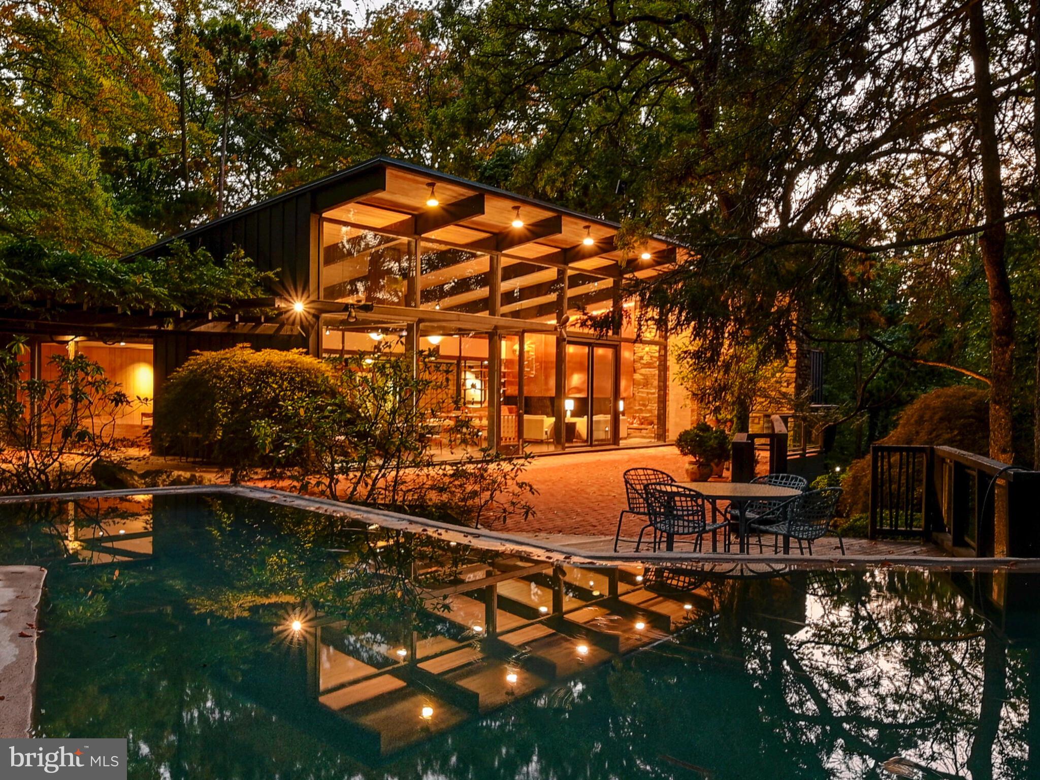 Offering two separately deeded dwellings on one 2.14 acre site, each with their own pool.   A Mid Century Modern Masterpiece, the main dwelling was built in 1956, inspired by its surrounding landscape, as crafted by famed landscape architect, James Rose - a major force in the design of the home as well.  The property borders the Jones Falls Trail, which extends from the Inner Harbor to the nearby Cylburn Arboretum. In 1961,  the property was awarded House and Garden's annual Hallmark designation which honors the country's best residential design of the year, commending the relationship of house and garden,  noting "it is hard to tell where one begins and the other ends."   This mid century work of art winds in and around its woodland site with layers of terraces, outdoor play and entertainment venues and water features, including an in-ground pool and open air fish pond around which the house revolves. Walls of glass invite the outside in, providing lovely views from this hilltop perch.  Nearly 5,200 sf on one level.  An open concept floorplan (still in vogue!) offers living and dining spaces enhanced by the soaring roofline and multiple access points to the expansive patios, including one to the rear of the home which flows from the generous family room/playroom. The original kitchen is as welcoming to a gourmand today as it was in 1956 - including the Alberene soapstone counters and well maintained cabinetry.  Five bedrooms and 5 1/2 baths.  Within walking distance to charming Mount Washington Village with its many shops and restaurants, and convenient access to I-83.

The property has witnessed additional development in the succeeding years. The owner's desire for a separate  space led to the 1971 creation on an adjacent separately deeded lot of an integrated yet private getaway (2309 Cross Country Boulevard).  An open concept design, the "Studio",  offers 1,200 sf of casual living and work spaces, including a fireplace, kitchen and full bath.  In 1991 a 1,900 sf  domed indoor pool  house  was added with amenities such as a kitchenette and a shower room. A Perfect opportunity for a remote office, inlaw dwelling or guest house.  True to the original  concept of the property, harmony with the woodland landscape is afforded with patios and terraces.  Qualified buyers, only, please.  ESTATE SALE - AS IS.
Sale includes Tax Id#'s 27-17-4675F-044 and 27-17-4675F-041.