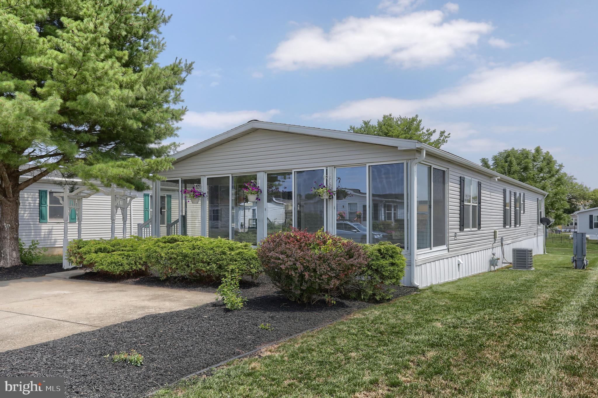 More than meets the eye. This spacious double-wide in the desirable 55+ Shadowstone community has been thoroughly renovated from head to toe, featuring a brand-new roof, furnace, central A/C, freshly painted siding, and a completely remodeled interior that is truly move-in ready. Inside, the home offers a versatile floor plan with two separate living areas, a breakfast nook that can also serve as a home office, vaulted ceilings, and three bedrooms. The comfortable primary suite includes a private full bath with a walk-in shower, jetted soaking tub, and a large wraparound vanity with exceptional counter and storage space. The updated kitchen features quartz countertops, refaced cabinetry, and a full suite of new appliances. New flooring and fresh paint extend throughout the home. An enclosed glass porch, large laundry room, and two storage sheds provide additional usable space and functionality. Residents enjoy the Shadowstone community clubhouse, fitness center, organized activities, and a central location with convenient access to Hershey, Lancaster, and Harrisburg. Land lease is $630/month.