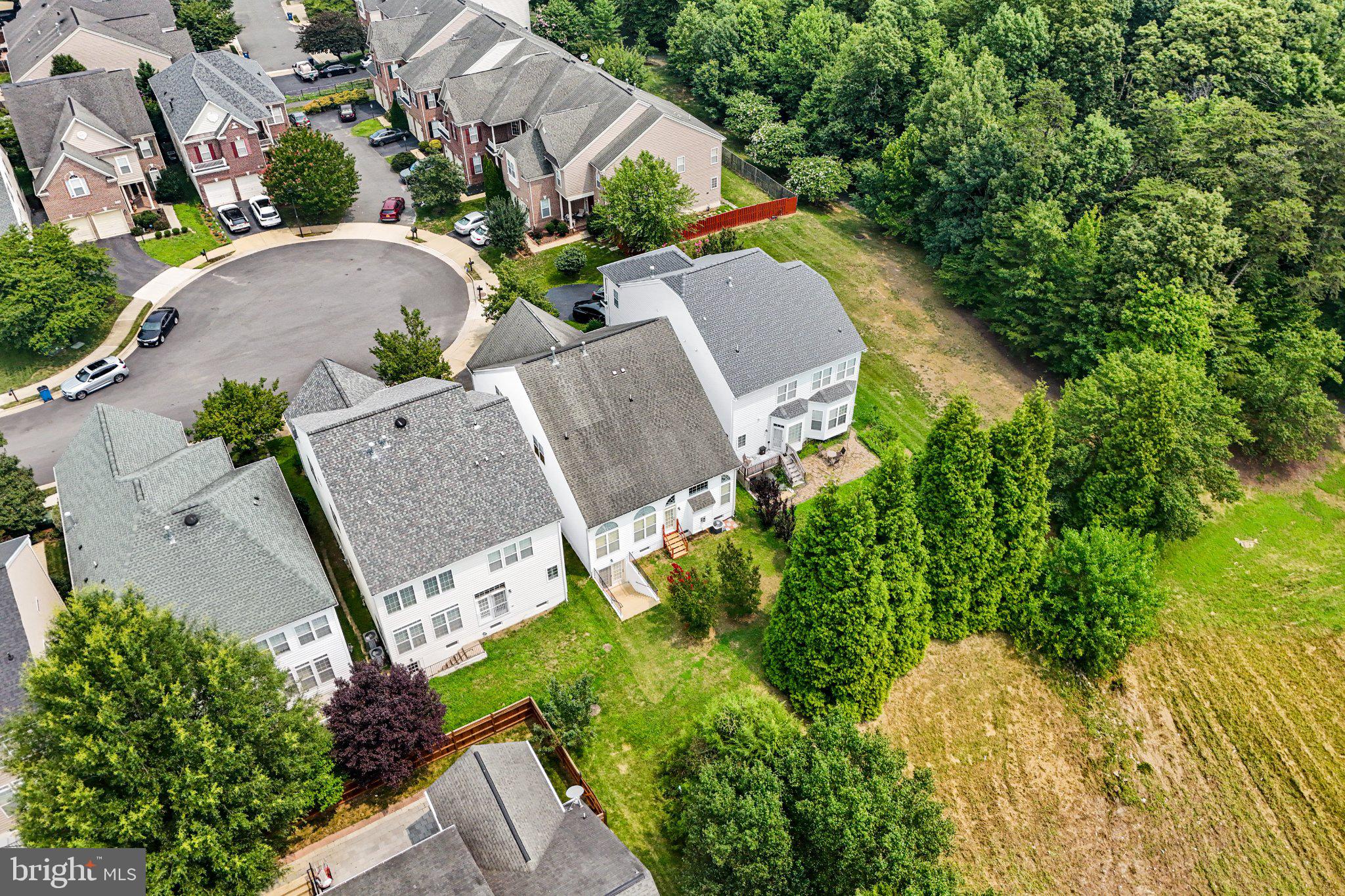 Nestled on a quiet cul-de-sac in the highly sought-after Village at Lorton Valley, this beautifully maintained brick-front colonial offers the perfect blend of timeless elegance, generous living space, and everyday convenience. Built in 2005, this exceptional home features 4 bedrooms, 4 full bathrooms, 1 half bath, a 2-car garage, and three finished levels designed for today's lifestyle.
A grand two-story foyer welcomes you inside, where hardwood floors, elegant columns, crown molding, and classic architectural details create a warm first impression. The main level includes a private home office, formal living room, and beautifully appointed dining room—ideal for entertaining or everyday living.
The gourmet kitchen is the heart of the home, showcasing granite countertops, a center island with a gas cooktop, double wall ovens, stainless steel appliances, a tile backsplash, abundant cabinetry, and a spacious breakfast area. It flows seamlessly into the stunning two-story family room, where soaring ceilings, oversized windows, rich hardwood floors, and a cozy gas fireplace create an inviting space filled with natural light.
Upstairs, you'll find a spacious primary suite along with generously sized secondary bedrooms and multiple full bathrooms, providing comfort and flexibility for family and guests.
The expansive walk-out lower level offers incredible versatility with a huge recreation room, luxury vinyl plank flooring, recessed lighting, a full bathroom, flexible bonus space perfect for a home gym, game room, playroom, home office, or guest accommodations, plus an oversized unfinished storage room with ample room for organization or future expansion.
Step outside to enjoy the rear deck overlooking a landscaped backyard with mature trees and direct access from the walk-out basement—perfect for relaxing or entertaining.
Conveniently located just minutes from I-95, Route 123, Fairfax County Parkway, Lorton VRE, Fort Belvoir, shopping, dining, parks, and recreation, this home offers the ideal combination of comfort, style, and commuter convenience.
Don't miss your opportunity to own this exceptional home in one of Lorton's most desirable communities!