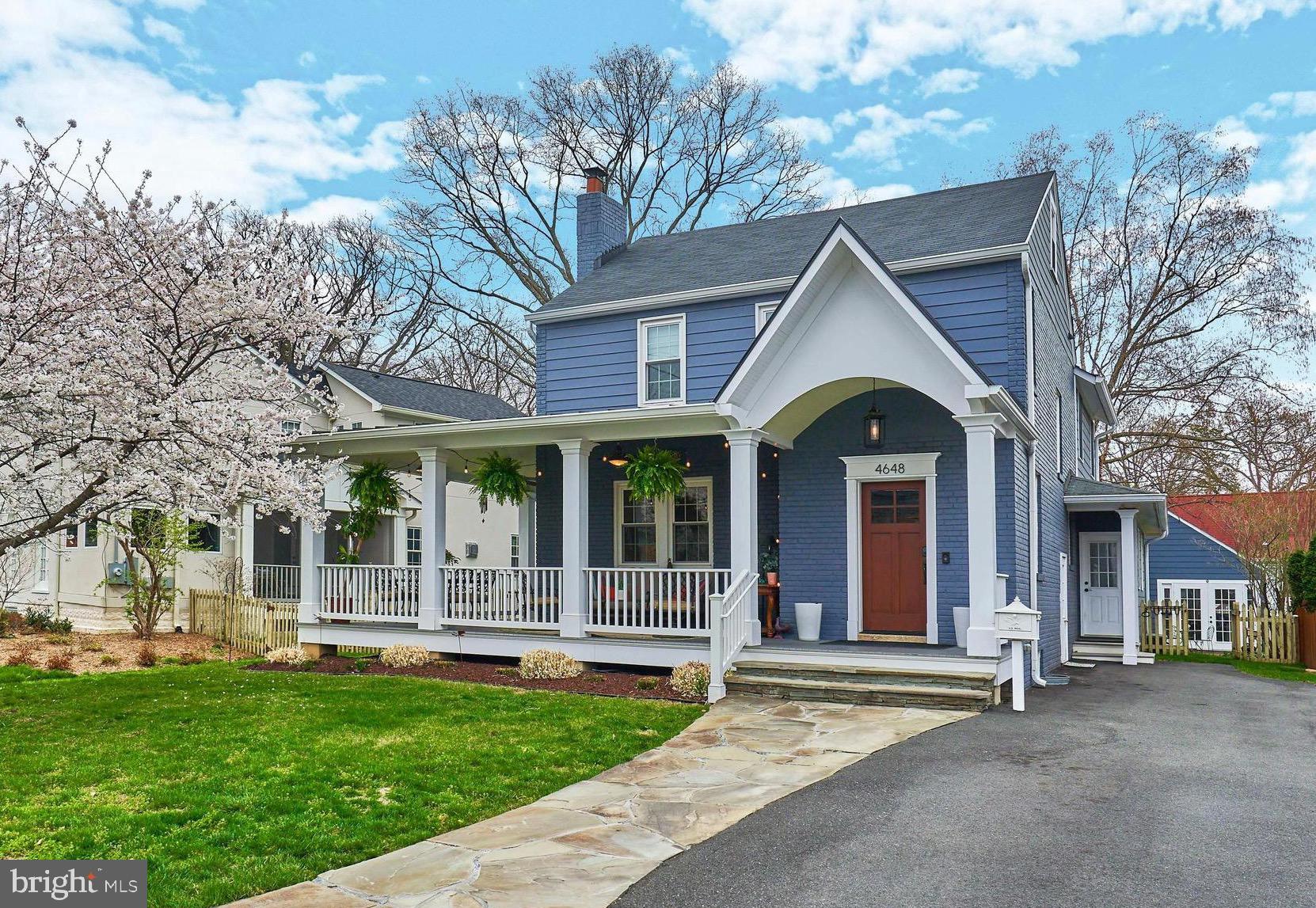 Beautiful expanded colonial with charm and functionality! Sweet stone walkway leads to a true wrap-around front porch — the kind that stops people in their tracks. Whether you're sipping morning coffee in solitude or hosting a lively gathering of neighbors and friends, this porch delivers the outdoor living experience most people only dream about. Settle in with a comfortable couch, pull up a table, and let the world drift by. From the moment you arrive, this home makes a statement.

Inside, the home is as warm and welcoming as its exterior promises. Entry foyer with coat closet sets the tone before opening into a generous living room anchored by a wood-burning fireplace — the perfect backdrop for cozy evenings in. The heart of the home is a large, open kitchen with room for a breakfast table or island seating, flowing effortlessly into the family and dining room. This connected, open space is designed for real life — casual weeknights, holiday gatherings, and everything in between. A wet bar with a beverage fridge and additional storage sits opposite the kitchen, making entertaining feel completely effortless. A powder room rounds out the main level nicely.

Tucked thoughtfully to the side is a mud room with a dedicated doggie shower, sink, storage, and closet space — because everyone deserves a great home. The side driveway entry creates a natural "friends and family" entrance that flows straight into the heart of the home.

At the back of the house, wide glass doors and a wall of windows pour light into the family room and frame a picture-perfect view of the covered rear patio. Stretching across the full width of the home, this outdoor space is another extension of the home.  Featuring a hard gas line for grilling and offers a peaceful, private retreat in a fully fenced backyard — ideal for entertaining, unwinding, or simply enjoying a quiet time outside.

The detached two-car garage has been thoughtfully converted into flexible bonus living space — envision a she-shed, home office, teen suite, man cave, playroom, or creative studio. It's the kind of space that adapts to your life, and having it just steps from your back door makes it feel like a true supplement to the home.

Upstairs, 4 bedrooms and two full baths offer room for everyone. The primary suite is a genuine retreat — spacious and serene, with built-in bookshelves, a spa-inspired bathroom featuring double sinks, a glass-surround shower, and a private water closet with linen storage. The oversized walk-in closet even includes a washer/dryer hookup for ultimate convenience. Three additional well-sized bedrooms share a beautifully renovated hall bath .

The partially finished lower level brings even more possibility — a half bath and laundry are already in place, and the open layout is a blank canvas ready to become a rec room, gym, media room, or guest suite. The hard work is done; the vision is yours.

And the location? Truly unbeatable. 4th of July block parties, Steps from Lee Heights shops and restaurants, minutes to Ballston, Clarendon, and Washington, D.C. Just blocks from Marymount University and Washington Golf & Country Club. A quiet footpath along Missionhurst leads all the way to the Potomac River — making this as connected to nature as it is to the city.  Discover ES, Williamsburg MS, Yorktown HS.