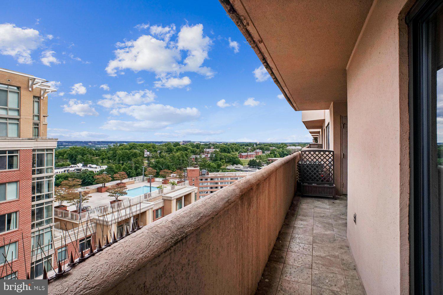 Spectacular 16th floor 2 BR/2 BA Condo Boasts Beautiful Skyline Views of the Potomac River and DC/Metro cityscape from every window*1,150 Finished Sq Ft Plus Amazing Large Balcony*Interior Just Freshly Painted & Brand New Carpet Installed in Both Bedrooms*Enormous Living & Dining Rooms are adorned with Wood Floors.  Inviting Kitchen features stainless steel appliances, granite counters, and breakfast bar.  Each Bedroom, on opposite ends of the unit, has great closet space with custom shelving and a designated full bath.  Front Load Washer & Dryer in unit and separate storage unit.  One garage parking space included.  Woodbury Heights is an established community with friendly 24/7 concierge, brand new lobby, outdoor pool, and a fitness center. You will love the bustling Courthouse neighborhood - the condo is right across from the largest farmers market in Arlington. The Courthouse metro station is a 4-minute walk, next to the AMC movie theater, multiple coffee shops, bars, quality restaurants, fitness studios, Whole Foods, Trader Joe's and more. It's a true walker's paradise! If you must drive, Route 50 is a block away - 3 minutes to the DC line, 10 minutes to Airport,  Alexandria and more.