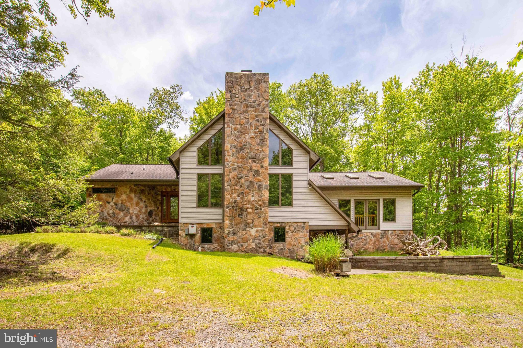 Welcome to mountain living at its finest.  Nestled on 6.89 private acres, 122 Woodlands Hill Lane offers the perfect blend of seclusion, space, and comfort in one of Garrett County’s most desirable settings. This impressive 4-bedroom, 4.5-bath home features approximately 4,000 square feet of living space designed for gathering, relaxing, and enjoying the beauty of Western Maryland.  The home sits on a 6.89-acre lot with surrounding  parcels also available.   Spacious living areas and multiple levels of comfort.

Inside, you'll find generous living spaces with warm finishes, hardwood flooring, and a fireplace that creates an inviting atmosphere year-round. The thoughtfully designed layout offers room for family and guests alike, while the expansive setting outside provides privacy and endless opportunities to enjoy nature. Features include a fireplace, wood stove, hardwood flooring, large basement, storage shed and  substantial interior space.  Other features include Anderson windows and doors, steam room/shower, infrastructure for central A/C and generator.  
Whether you're looking for a full-time residence, a mountain retreat, or a place to create unforgettable memories near Deep Creek Lake, this property delivers a rare combination of acreage, privacy, and convenience. Enjoy the peaceful surroundings while remaining just minutes from Deep Creek Lake recreation, dining, state parks, Wisp Resort, and all the outdoor adventures Garrett County has to offer.
Your mountain escape awaits.   Call today!
The following surrounding parcels are also available for sale, please inquire.    
Parcel 657 - 3.15 ACRES   
Parcel 634  - 5.0 ACRES  
Adjoining parcel 658 also for sale:  6.89 ACRES -  MLS #MDGA2011974  can also be purchased from separate owner