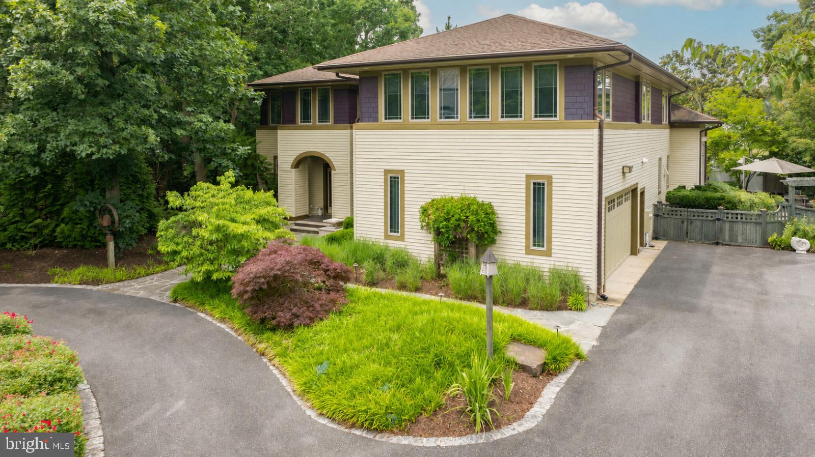 Five bedrooms. A heated saltwater pool. A fifteen-minute walk to the Rehoboth Beach boardwalk.
That combination is exceptionally rare.

Most homes of this size in Coastal Delaware require a drive to the beach. This one doesn't. Set on nearly one-third of an acre surrounded by mature landscaping, this 4,829-square-foot custom residence offers exceptional privacy without sacrificing walkability to downtown Rehoboth Beach, the Atlantic Ocean, fine dining, and the Boardwalk. Inside, ten-foot ceilings define the main level before opening into a vaulted great room filled with natural light from the rear elevation. Custom oak millwork, rich architectural detailing, and thoughtfully scaled living spaces create a home equally suited for everyday living and effortless entertaining.

The kitchen centers around a professional-grade range, quartz countertops, custom cabinetry, a walk-in pantry, and an oversized island with seating space. Designed for effortless entertaining, the kitchen is equipped with two dishwashers to easily accommodate large gatherings and extended family stays. Radiant heated floors beneath the kitchen and primary bath provide welcome comfort throughout the cooler coastal months. The primary suite offers generous proportions and privacy, while four additional bedrooms and multiple living areas provide flexibility for guests, a home office, recreation, or extended stays. A dedicated utility room features a sink, additional cabinetry, and a built-in custom china cabinet, while two washers and two dryers provide exceptional convenience for large households, vacation guests, or rental turnovers. A projector and surround sound system create an immersive setting for movie nights, sports, and entertaining. A whole-house-and-garden sound system plays individualized selections. Skillfully designed combination of open-plan living with discrete living/dining options–four seating areas for flexible entertaining, both formal and casual.

Outdoor living is every bit as impressive. Natural stone creates distinct spaces for dining, relaxing, and entertaining, including a spacious terrace, flagstone surrounding the heated saltwater pool and attached spa, and a screened porch finished with a beadboard ceiling. Mature landscaping surrounds the property, creating remarkable privacy. From nearly every outdoor living space, the property line disappears behind established plantings.

Residents of Canal Corkran enjoy walking paths and a community pool, with Gordon's Pond, the Junction & Breakwater Trail, and Cape Henlopen State Park all nearby. Whether you're walking into town for dinner, spending the afternoon by the heated saltwater pool, or gathering friends for a movie after the beach, this is a home designed to enjoy everything Rehoboth Beach has to offer—without ever giving up the space, privacy, and comfort of a custom residence.