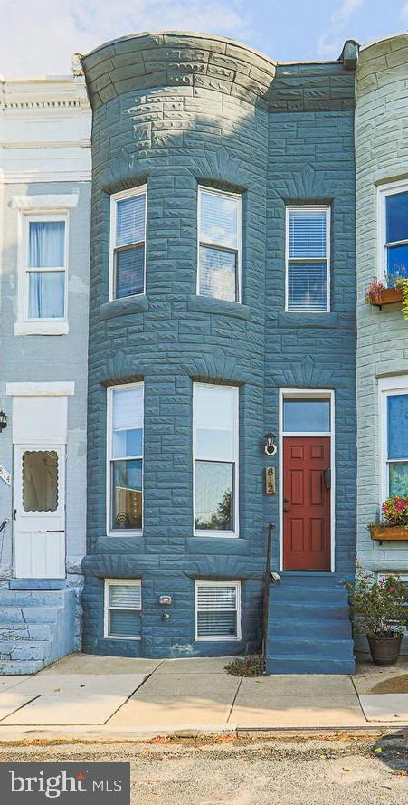 Welcome to this beautifully renovated 3-bedroom, 3-full-bath townhome in the heart of Historic Hampden. Renovated in 2018, this move-in-ready home blends classic Baltimore character with modern finishes throughout. The open-concept main level features exposed brick, hardwood floors, abundant natural light, and a well-appointed galley kitchen with granite countertops, breakfast bar, wine cooler, and access to the rear deck and private parking pad.

The upper level offers a spacious primary suite with a private bath featuring a sliding barn door, a second generously sized bedroom, an additional full bath, walk-in closet, and convenient upper-level laundry. The mostly finished lower level includes a third bedroom, full bath, large storage area, second laundry hookup, and flexible space ideal for guests, a home office, fitness room, or recreation area.

Located just blocks from Hampden's popular "The Avenue," this home is convenient to local restaurants, shopping, breweries, parks, The Rotunda, Johns Hopkins University, downtown Baltimore, and major commuter routes. Johns Hopkins University employees may be eligible for up to $18,500 in homebuyer assistance through the Live Near Your Work Program. Buyers are responsible for verifying eligibility and current program requirements directly with Johns Hopkins University.

Additional highlights include three full bathrooms, beautiful hardwood flooring, exposed brick accents, a wine cooler, abundant natural light throughout, a finished lower level offering additional living space, convenient upper-level laundry, and a private rear parking pad—making this home the perfect combination of historic charm, modern convenience, and one of Baltimore's desirable walkable neighborhoods. Don't miss your opportunity to call Hampden home!