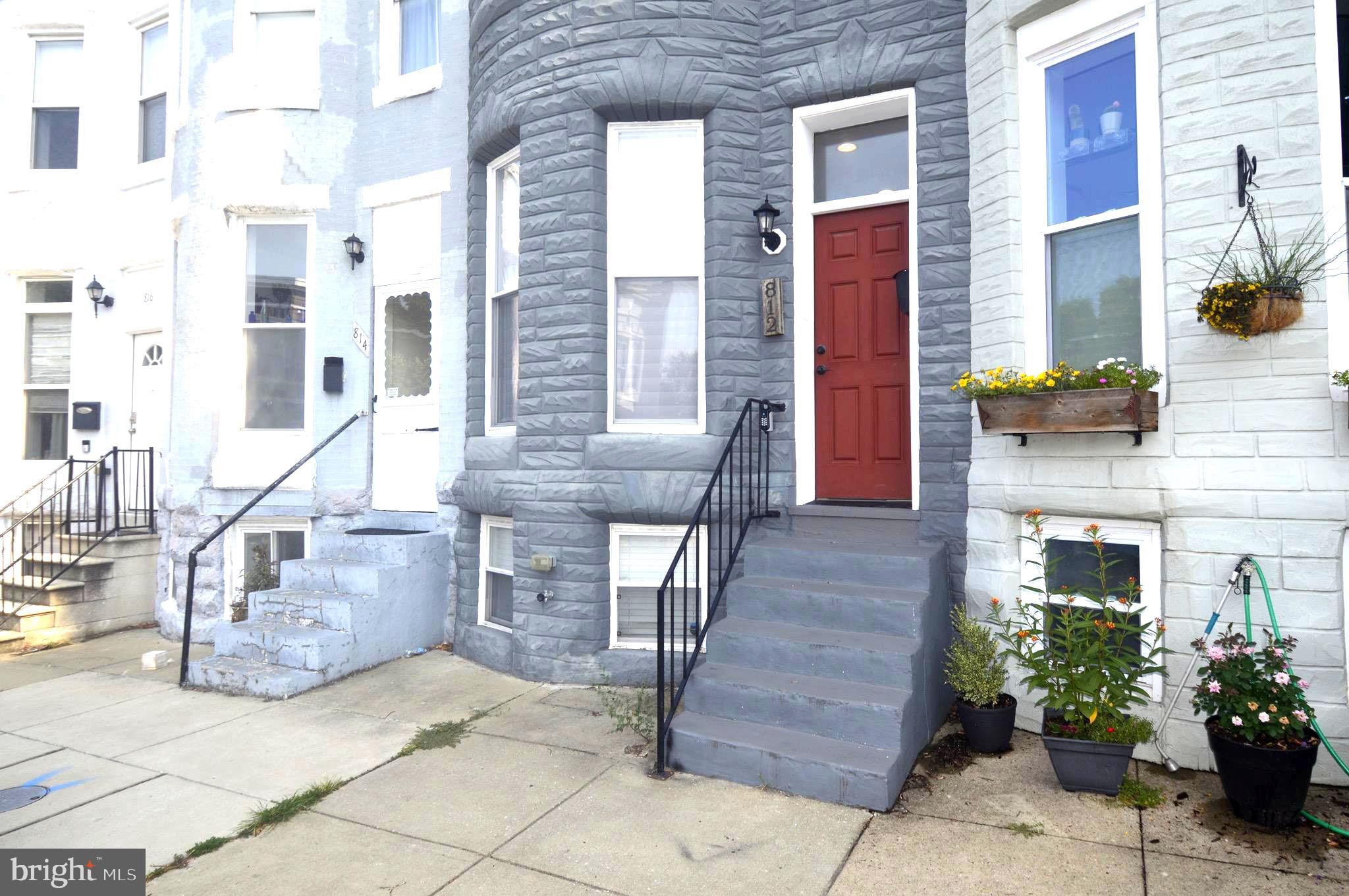 Welcome to this beautifully renovated 3-bedroom, 3-full-bath townhome in the heart of Historic Hampden. Renovated in 2018, this move-in-ready home blends classic Baltimore character with modern finishes throughout. The open-concept main level features exposed brick, hardwood floors, abundant natural light, and a well-appointed galley kitchen with granite countertops, breakfast bar, wine cooler, and access to the rear deck and private parking pad.

The upper level offers a spacious primary suite with a private bath featuring a sliding barn door, a second generously sized bedroom, an additional full bath, walk-in closet, and convenient upper-level laundry. The mostly finished lower level includes a third bedroom, full bath, large storage area, second laundry hookup, and flexible space ideal for guests, a home office, fitness room, or recreation area.

Located just blocks from Hampden's popular "The Avenue," this home is convenient to local restaurants, shopping, breweries, parks, The Rotunda, Johns Hopkins University, downtown Baltimore, and major commuter routes. Johns Hopkins University employees may be eligible for up to $18,500 in homebuyer assistance through the Live Near Your Work Program. Buyers are responsible for verifying eligibility and current program requirements directly with Johns Hopkins University.

Additional highlights include three full bathrooms, beautiful hardwood flooring, exposed brick accents, a wine cooler, abundant natural light throughout, a finished lower level offering additional living space, convenient upper-level laundry, and a private rear parking pad—making this home the perfect combination of historic charm, modern convenience, and one of Baltimore's desirable walkable neighborhoods. Don't miss your opportunity to call Hampden home!