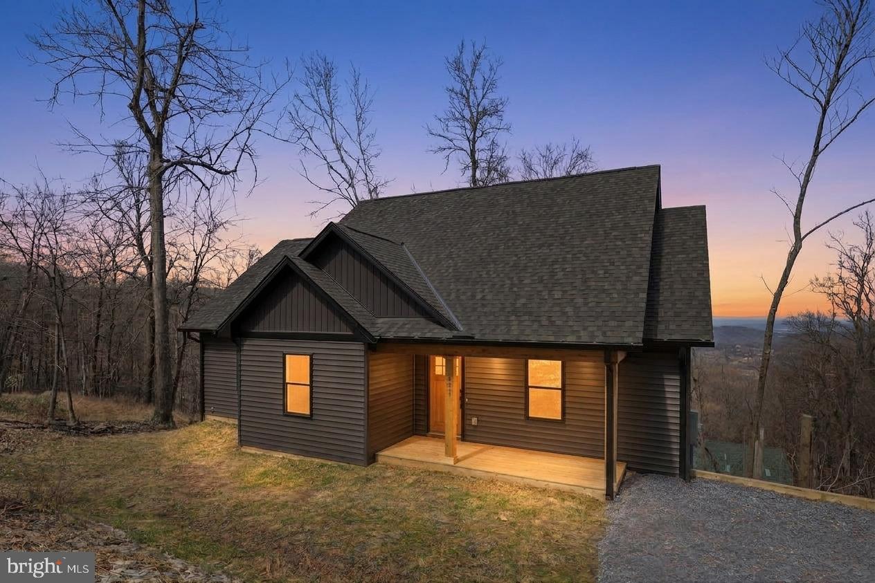 Located in the gated community of High Knob, 377 Windy Way in Front Royal offers the perfect blend of modern comfort and peaceful mountain living. This brand-new, completely finished home is thoughtfully positioned to capture breathtaking views of the Shenandoah Valley while offering a serene setting surrounded by nature. Situated on a 0.58-acre lot, the property provides room to relax and enjoy the beauty of the outdoors, all while being conveniently located just 6 miles from I-66 and 6 miles from the Town of Front Royal for easy access to commuting, shopping, dining, and everyday conveniences.

This thoughtfully designed home features true one-level living with 3 bedrooms and 2 full bathrooms, combining comfort, style, and functionality. Step inside from the covered front porch into an open-concept layout where the living room, kitchen, and dining area flow seamlessly together beneath vaulted ceilings, creating a bright and airy atmosphere. Elegant modern finishes are carried throughout the home, offering a clean, stylish feel from room to room.

The primary suite provides a comfortable retreat with an ensuite bathroom, a spacious walk-in closet and direct access to the covered porch, perfect for stepping outside to enjoy fresh mountain air or take in the views.

The unfinished basement is already rough-plumbed for a future bathroom, offering excellent potential for expansion—whether you envision additional living space, a guest suite, or a workshop, along with ample storage.

Step outside to the covered back deck, where you’ll be captivated by sweeping, elevated views of the Shenandoah Valley stretching for miles. From peaceful mornings with coffee to colorful evening sunsets, this space offers a front-row seat to the natural beauty that surrounds you.

Residents of High Knob enjoy a wide range of amenities, including a clubhouse, pool, tennis and basketball courts, playground, and year-round community events. Pool access and road maintenance are included in the sanitary district fee, and the community offers public water service, eliminating the need for individual wells. Outdoor enthusiasts will love the direct access to the Appalachian Trail, while abundant wildlife and the serene mountain setting complete the experience.

Located just a short walk from the community clubhouse and pool, this home blends scenic mountain living with an active and amenity-rich community. Please note that short-term rentals are not permitted.
