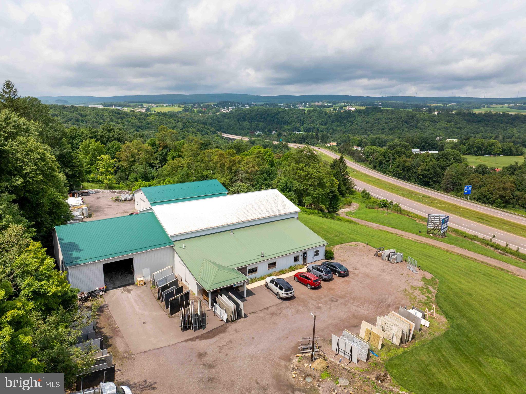 Unlock the potential of this remarkable 75.32-acre investment property, strategically positioned along a highly traveled highway, offering outstanding visibility, convenient access, and endless possibilities for future growth. This unique offering consists of four separate parcels, making it an ideal opportunity for investors, developers, or business owners seeking versatile property with multiple income-producing possibilities.
The property features commercial buildings with roughly 14,000 SF that are ready to accommodate your business, providing immediate operational potential while benefiting from excellent highway exposure. In addition to the commercial improvements, the property also includes a residential home, offering the convenience of on-site living, employee housing, or rental income.
For those looking to expand, the opportunities continue. Lot 4 includes five approved septic locations, providing the ability to build several additional homes and significantly increase the property's residential or investment potential. Whether you're envisioning a mixed-use development, employee housing, rental properties, or private estate, this property offers the flexibility to bring your vision to life.
Backing to peaceful wooded acreage with no-through street, the property combines commercial accessibility with the privacy and natural beauty that today's buyers and tenants appreciate. The expansive acreage offers ample room for future development while maintaining a tranquil setting that enhances both residential and commercial appeal.
Originally constructed in 1984 and expanded a few times, the existing improvements feature durable metal siding and quality construction designed for long-term performance and minimal maintenance.
Ample parking, open usable land, and excellent access further enhance the property's functionality and desirability.
Properties offering this combination of commercial infrastructure, residential living, future development opportunities, and substantial acreage are exceptionally rare. Whether your goal is to establish or expand a business, develop additional homes, generate rental income, or create a diversified investment portfolio, this one-of-a-kind property delivers unmatched potential in a growing market.
Don't miss this opportunity to own a highly visible, multi-use property with immediate income potential and room for future expansion.