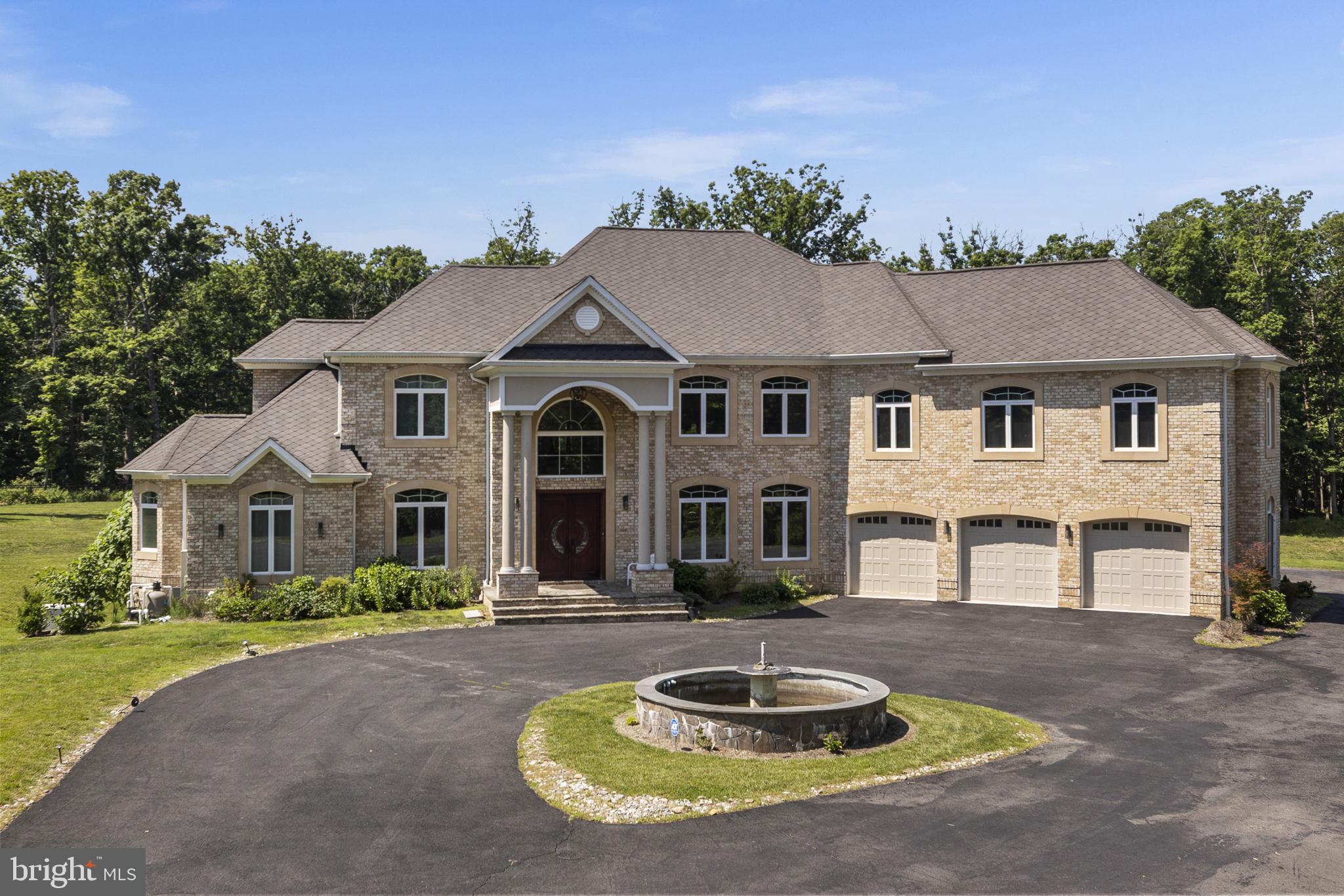 Located on Clifton's most desirable street, just minutes from Fairfax, off Braddock Road, I-66, and major highways, this stately gated estate offers exceptional luxury, privacy, and convenience on over 5 pristine acres. Surrounded by grand custom estates and tucked away at the end of a private street, it provides a peaceful retreat just minutes from everything. Built in 2016, the approximately 9,000-square-foot residence showcases high-end finishes throughout, featuring a sought-after main-level primary suite and a butler's pantry, making the home ideal for multigenerational living and effortless entertaining. An elevator provides seamless access to every level. Designed for both entertaining and relaxation, the home includes a private movie theater with surround sound, a custom wet bar, a sauna, a fully equipped gym, and a whole-house generator. The property also features a charming chicken coop and backs to mature trees, creating a private, serene setting with picturesque views.