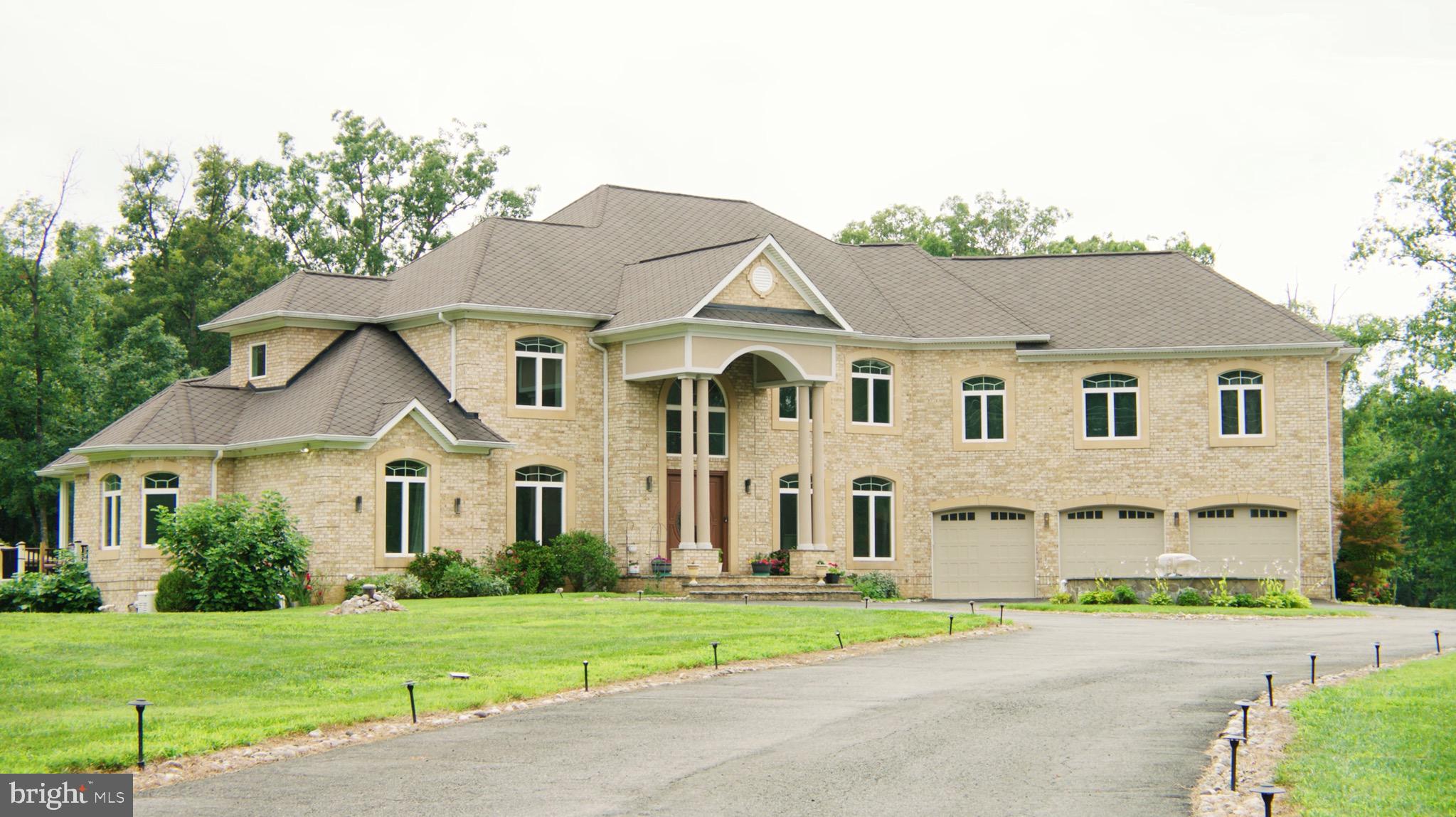 Located on Clifton's most desirable street, just minutes from Fairfax, off Braddock Road, I-66, and major highways, this stately gated estate offers exceptional luxury, privacy, and convenience on over 5 pristine acres. Surrounded by grand custom estates and tucked away at the end of a private street, it provides a peaceful retreat just minutes from everything. Built in 2016, the approximately 9,000-square-foot residence showcases high-end finishes throughout, featuring a sought-after main-level primary suite and a butler's pantry, making the home ideal for multigenerational living and effortless entertaining. An elevator provides seamless access to every level. Designed for both entertaining and relaxation, the home includes a private movie theater with surround sound, a custom wet bar, a sauna, a fully equipped gym, and a whole-house generator. The property also features a charming chicken coop and backs to mature trees, creating a private, serene setting with picturesque views.