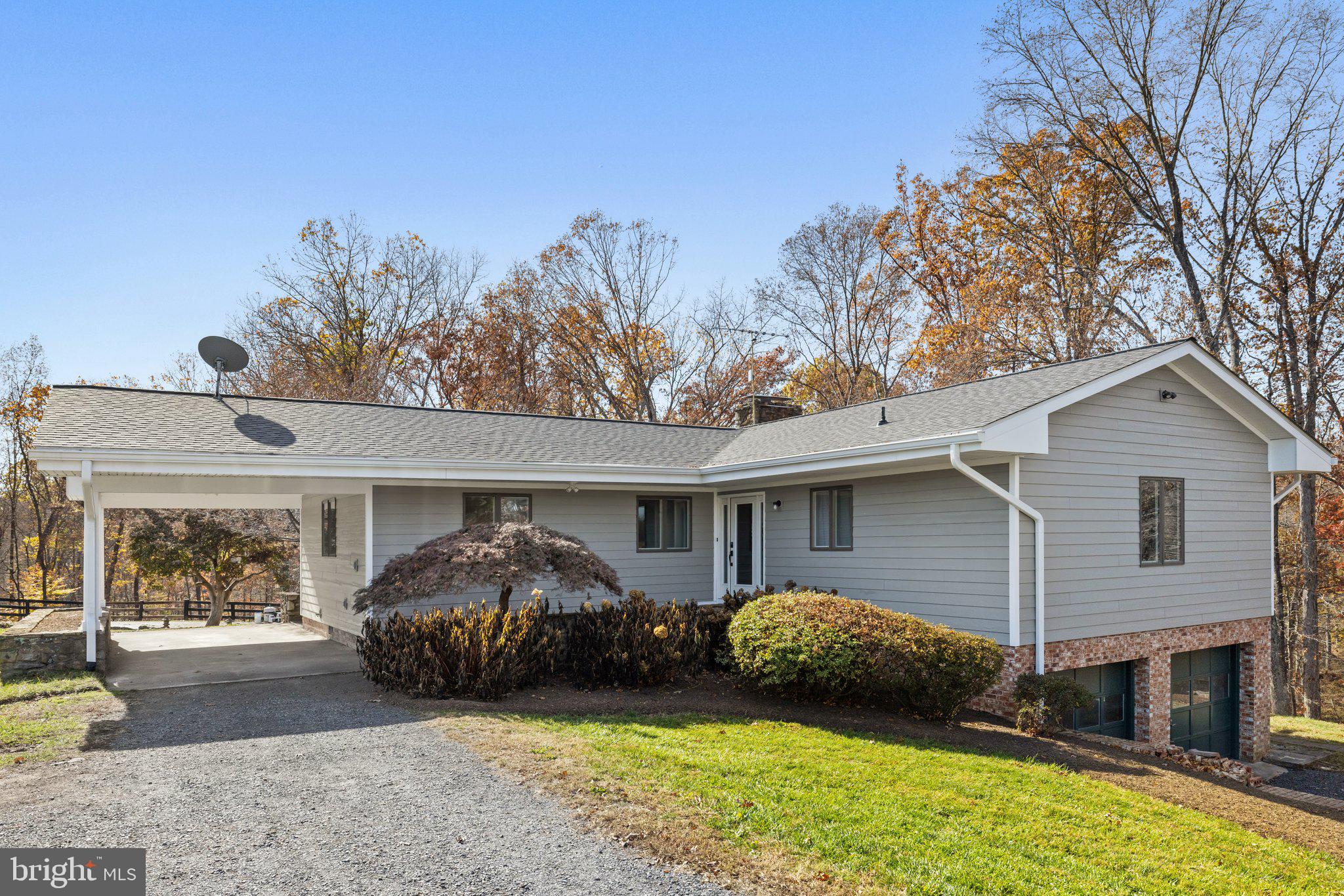 Back on the market!! Built in 1974, the home offers beautiful wood vaulted ceilings, and wood flooring in the living and dining rooms, both of which open onto a deck overlooking private woodland. The handsome floor to ceiling stone fireplace divides the living room from the dining room and features a wood stove insert and raised stone hearth on the living room side and an indoor grill on the dining room side.
 The U shaped kitchen features a pass-through to the dining room adding a feeling of openness to the room.  A carport at the main level offers direct access to the kitchen.
 The primary bedroom on the main level, features a door to the terrace leading to the pool. This is a very private suite with private bath and three closets. Two additional rooms and full bath complete the main level.
 The lower level offers an additional bedroom, full bath and a wonderful family room with Brazilian rosewood cabinets and shelving. The hallway features a wet bar and direct access to the attached two car garage.
 The exterior of the home is hardi plank and the owner had the interior freshly painted and new carpeting installed. This home is very livable while offering excellent potential to have a stunning home surrounded by woods.
This home would also make a great hunt box in Middleburg Hunt territory. It offers one 4-stall barn with tackroom/laundry room, a wash stall with cold and hot water, hay loft, and two storage areas for equipment. The stalls are all equipped with rubber mats. There is also a two stall run-in shed in the paddock in front of the barn with a hay loft. The second paddock also has a run-in shed. Great ride out potential! 
Property is in land use- seller will not be responsible for roll back taxes if purchaser removes any of the land from land use.