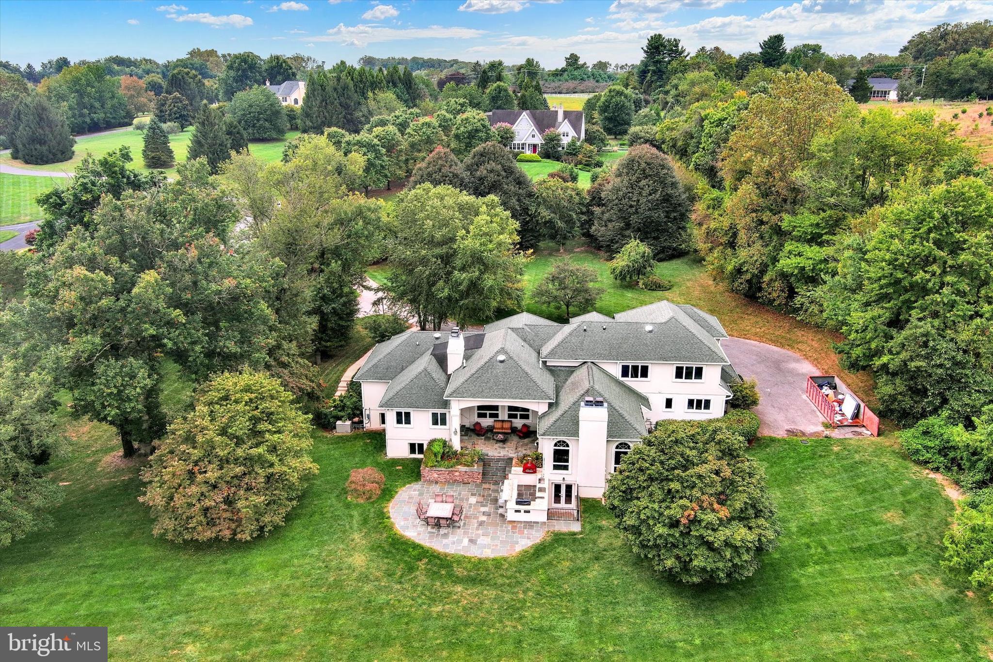 A rare offering within a private, gated equestrian community - This exceptional home is set in the highly sought-after Blenheim Farm. Situated on over three acres, the property offers luxury, tranquility, and an elevated lifestyle for those who value privacy and space. The beautifully landscaped backyard is an entertainer’s dream, featuring an outdoor kitchen, pizza oven, and expansive grounds with ample space for gatherings under the stars. Inside, the expansive first floor showcases a primary suite retreat, a chef’s kitchen equipped with a large Wolf range, a family room with fireplace, formal dining room, private study, and a versatile laundry/mudroom that seamlessly blends form and function. The fully finished lower level is ideal for multi-generational living or hosting guests, offering a complete in-law suite, game room, and a spacious family room with fireplace and full bar—perfect for game nights and celebrations. Additional highlights include a three-car garage with abundant storage.  Residents can enjoy the unique benefits of equestrian living, including shared paddocks and a stable. This is more than just  a home—it’s a lifestyle. Don’t miss the opportunity to live in Blenheim Farm. A truly must-see property.