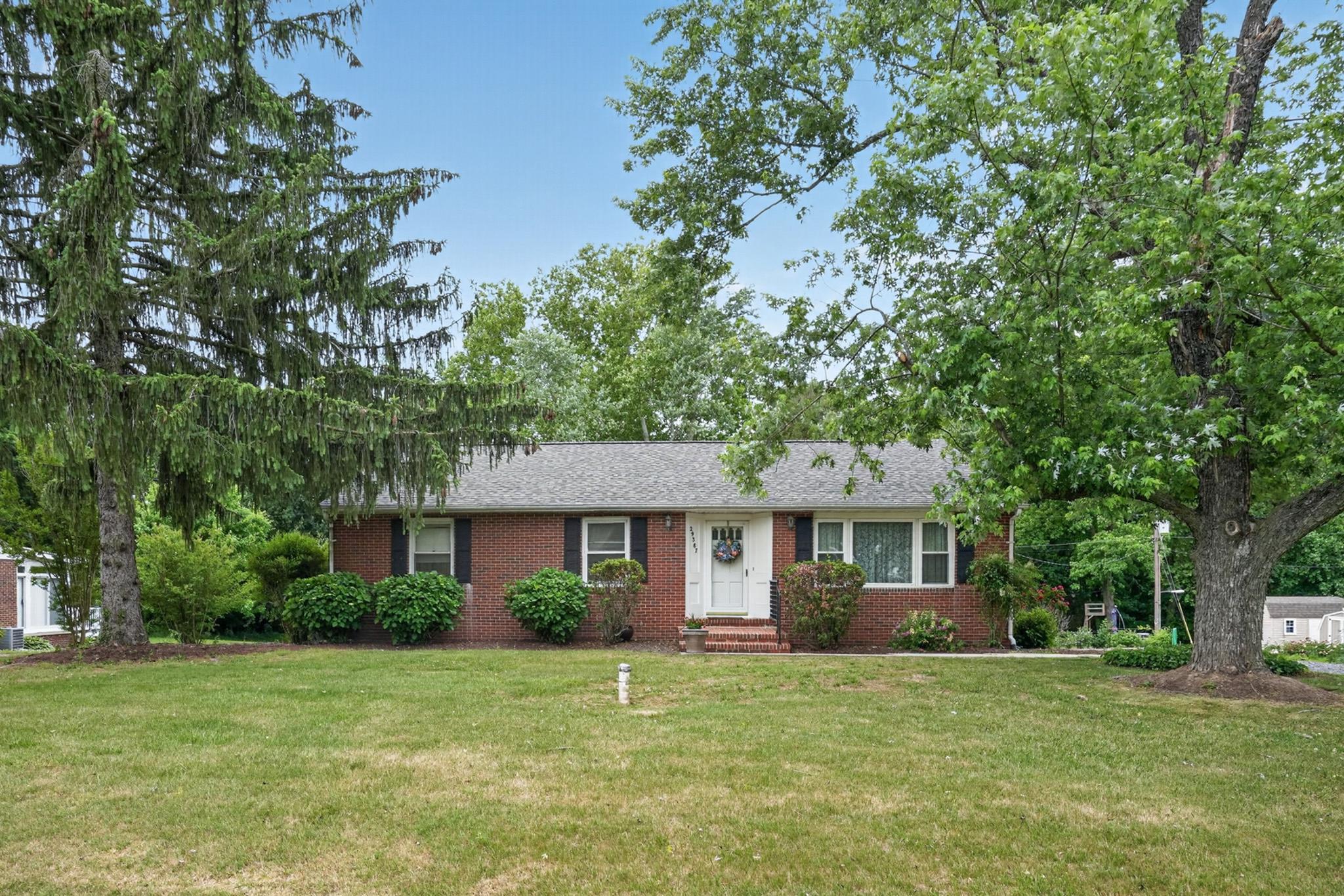 BRAND NEW ROOF and additional upgrades in 2026! The impeccably well-maintained RAISED RAMBLER with a lower level and attached garage is deceptively spacious. The surprisingly large interior defies its smaller exterior appearance. Sitting on a picturesque half-acre lot and boasting over 3,450 sq. ft. of total living space. Perfectly designed to support MULTI-GENERATIONAL or ONE LEVEL LIVING. Get excited as you step into the bright and spacious living room and a formal dining room attached to a delightful family room – with a beautiful wood burning fireplace. The main level also includes a large, FRESHLY PAINTED eat-in kitchen, 3 bedrooms, and 2 full baths. Next, escape to the PRIMARY ENSUITE, a true private retreat complete with its own sitting room, walk-in closet, and an elegant bathroom. The excitement continues downstairs on the spacious FINISHED LOWER LEVEL, an inviting haven that blends plush comfort for effortless entertaining. A dedicated half bath, a welcoming recreation room perfect for movie nights and casual gatherings, a spacious laundry room with abundant cabinet and counter space, and a mud room leading to the garage are only half of what the expansive lower level has to offer. Step into the 2nd half which includes 3 VERSATILE/MULTI-PURPOSE Bonus Rooms providing endless flexibility for a home office, workshop, gym, and a private guest suite. And don’t miss the sundrenched, all-season enclosed sunroom offering year-round relaxation and stunning views of the private garden, and lush park-like backyard. The spacious backyard, which includes a small stream at the end of the property, is ready for hosting guests on the patio and the newly updated deck. This prime location is off Route 50 with shopping, dining, recreational activities, and exciting arts and cultural events to enjoy. Easy access to Ocean City, Annapolis, Baltimore, Washington, D.C., and Delaware.

Qualified borrowers are eligible for a $3000 grant from FHM, a reduced interest rate and reduced mortgage insurance. Schedule your private tour today and discover your future on the Eastern Shore!