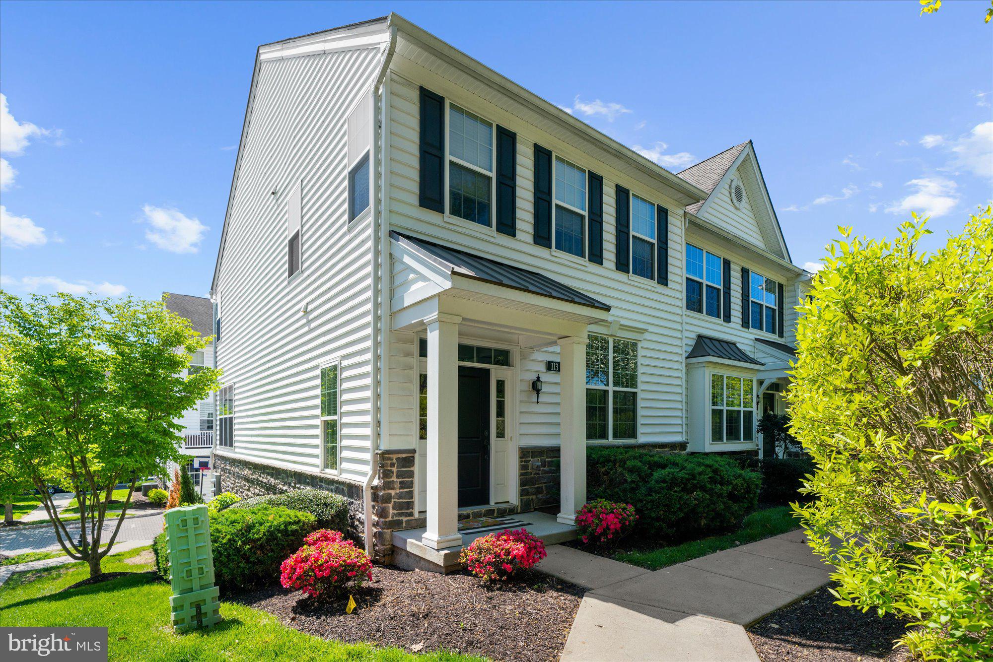 Welcome to this beautifully maintained townhome in the sought-after Ravenscliff community. Built in 2017 and enhanced by its coveted end-unit location, this sun-drenched, move-in ready home offers the perfect blend of comfort, functionality, and modern living.

An abundance of windows fills the home with natural light, while rich hardwood flooring throughout the main level and second-floor hallway creates a warm and inviting atmosphere.

At the heart of the home is a beautifully appointed kitchen featuring quartz countertops, stainless steel appliances, a center island ideal for gathering, and an adjoining breakfast area bathed in natural light. Sliding doors lead to a private deck, offering the perfect setting for morning coffee, outdoor dining, or unwinding at the end of the day.

The open-concept layout flows effortlessly into the oversized living room, creating an ideal space for both everyday living and entertaining. A conveniently located powder room completes the main level.

Upstairs, the spacious primary suite serves as a private retreat, featuring a large walk-in closet and an oversized ensuite bath. Two additional bedrooms share a hall bathroom, while the second-floor laundry room adds convenience to daily life.

The versatile lower level offers exceptional flexibility to suit your lifestyle. Whether used as a fourth bedroom, home office, gym, playroom, or media room, the space adapts to your needs. A plumbing rough-in presents the opportunity to add an additional full bathroom, creating the potential for a guest suite or private living quarters. Direct access to the attached two-car garage completes this level.

Offering abundant natural light, thoughtful upgrades, flexible living spaces, and the ease of low-maintenance living, this exceptional end-unit is a place you'll be proud to call home.
