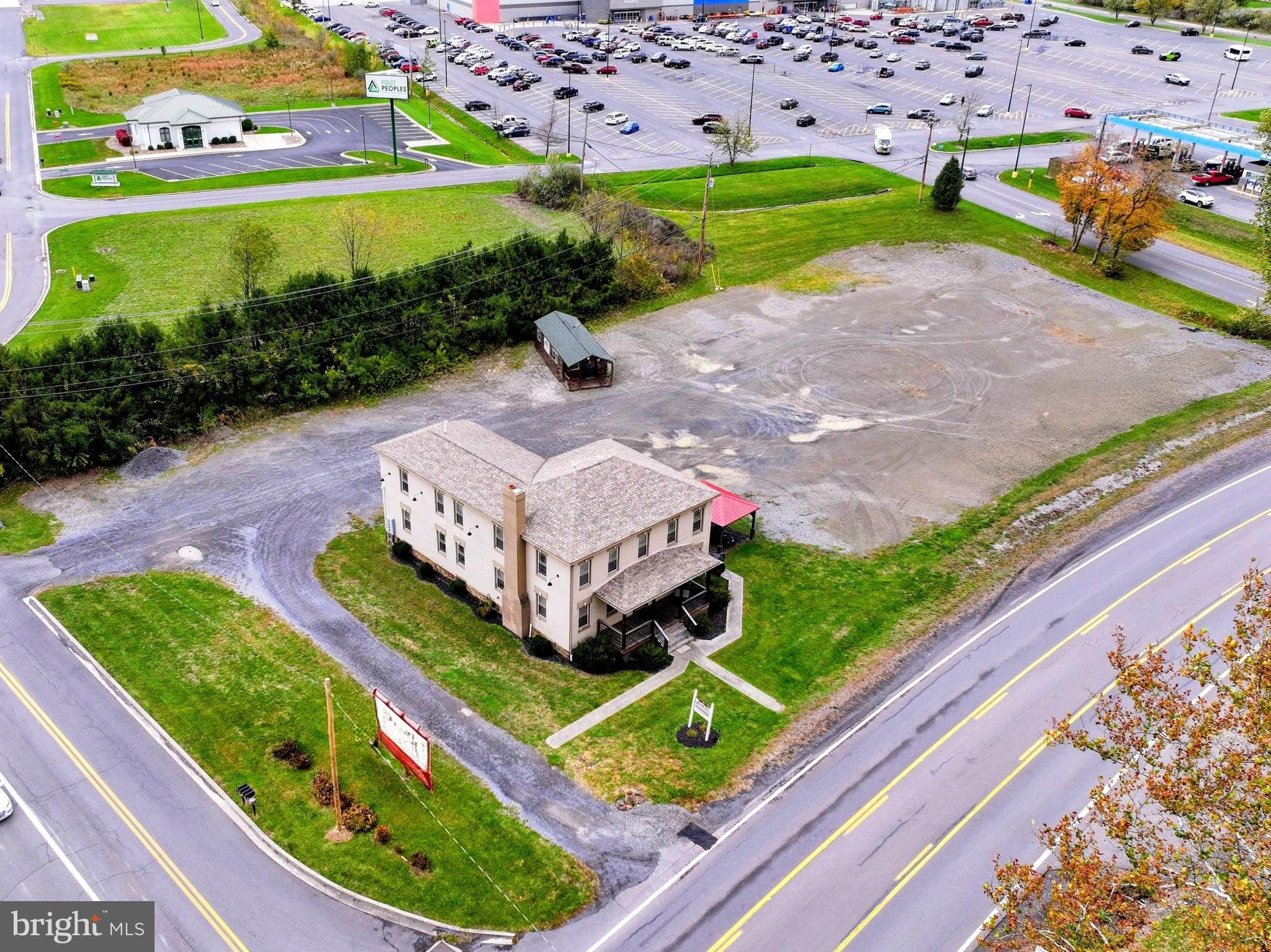 Outstanding investment opportunity along Route 93 / New Creek Highway, right next to the Walmart Supercenter! This property is 1.53 acres of level land with 330' of road frontage and two vehicle access points to New Creek Highway - traffic  volume of 5,000 to 7,000 cars per day! Currently producing steady rental income from a quadraplex, the site also holds exceptional commercial or business development potential thanks to its high-traffic location and public utilities on site.

Whether you're looking to expand your franchise, develop retail or office space, or establish a new business, this property offers the perfect blend of income, location, and future growth potential. Strong visibility, easy access, and endless possibilities.