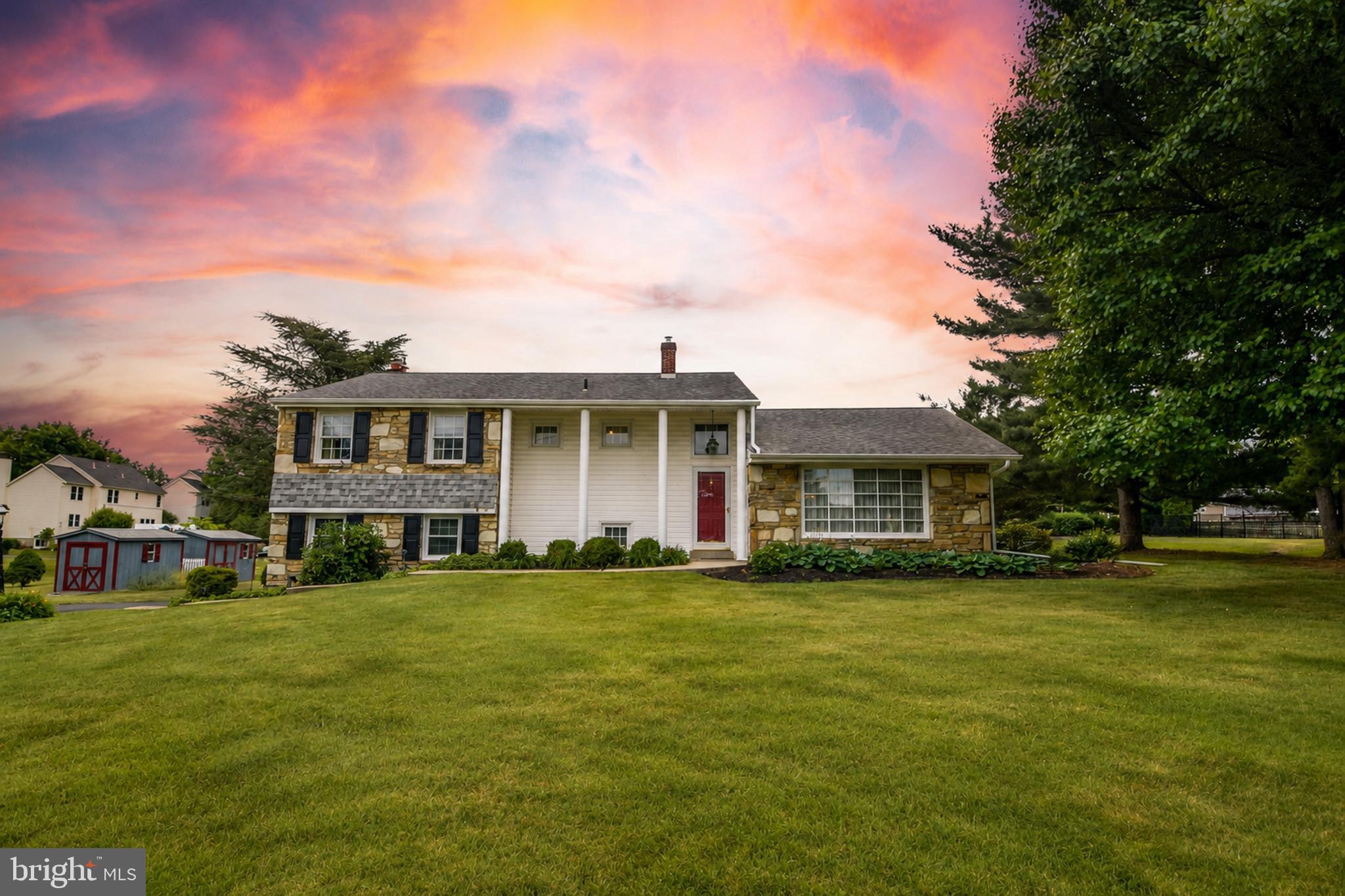 Open House Saturday 7/11,  Time: 11-3 and Sunday 7/12, Time: 2-4.  Welcome to this spacious 4 bedroom, 2.5-bath home with an oversized one-car garage, located in the highly sought-after Souderton Area School District in Bucks County. Situated on a generously sized lot with excellent curb appeal, this home offers the perfect combination of comfort, space, and functionality. A large covered front porch welcomes you into a bright and inviting main level featuring beautiful hardwood flooring, a spacious living room, a formal dining room, and an updated kitchen with granite countertops and a cozy breakfast nook. The lower level offers a generously sized family room with a propane fireplace and an abundance of natural light, making it the perfect place to relax or entertain. This level also includes a convenient half bath, a utility/laundry room with washer and dryer, and access to the oversized garage, which provides plenty of additional storage. Upstairs, you'll find four spacious bedrooms and a full hall bathroom. The primary suite features its own private full bath, creating a comfortable retreat. Step outside to enjoy the large backyard and patio, ideal for entertaining, outdoor dining, or simply relaxing. Additional features include a driveway with parking for six or more vehicles and two storage sheds to meet all of your storage needs. Don't miss the opportunity to make this wonderful Bucks County home your own!