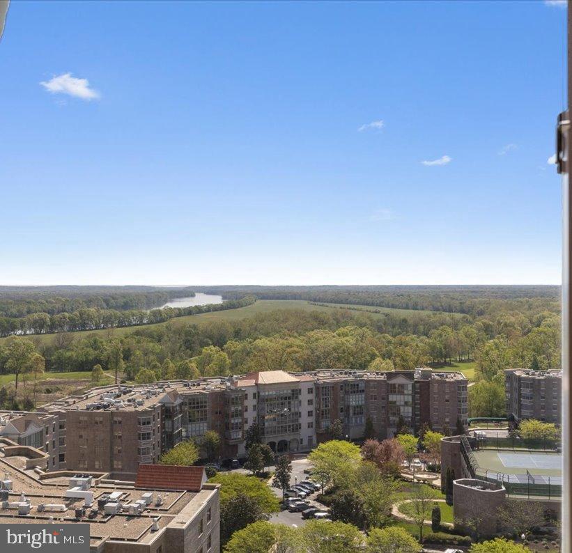 Experience the View, Live the Easy Lifestyle — Riverview Elegance in Lansdowne Woods

Welcome to 19355 Cypress Ridge Terrace #1007, where comfort meets sophistication in the youngest high-rise at award-winning Lansdowne Woods of Virginia. Built by IDI Cortese in 2006, Riverview offers resort-style amenities with panoramic views that stretch up the Potomac River—and from this 10th-floor perch, you’ll enjoy incredible sunrises and a breathtaking outlook over the impeccably maintained community below.

This spacious Riverview Model G floor plan includes 1,315 square feet of well-designed living space, incorporating a 152 square foot glass-enclosed and climate-controlled sunroom that’s as perfect for morning coffee as it is for evening reflection. The split-bedroom layout ensures privacy, while the living areas blend elegance and function in all the right ways. The primary suite features two walk-in closets with an ensuite offering a tub/shower, a walk-in shower, and a comfort-height single sink vanity.  

The centrally located living and dining room also enjoys balcony access and provides space to entertain family and friends.  The stylish kitchen boasts granite counters, painted cabinets, a peninsula for serving and prepping, and stainless steel appliances—all refreshed within the past four years. The kitchen has storage aplenty, a sunny breakfast room, and access to the sunroom.  

The spacious laundry room is also being cleverly used as a home office.  The room is large enough to repurpose with enough space for shelving, a pantry, a side-by-side washer and dryer, or even an extra refrigerator or freezer. 

Highlights include updated engineered wood and LVP flooring, ceramic tile floors and backsplash, classic crown and chair rail molding, and freshly painted walls.

Enjoy the convenience of an oversized garage space (#29) with cabinets, plus a climate-controlled storage cage. The monthly Condo and HOA fee of $803.22 includes water, sewer, trash, internet, TV, and access to phenomenal amenities at the newly remodeled clubhouse—an indoor pool, fitness center, restaurant, clubhouse, walking trails, art studio, woodworking shop, ceramics studio, chapel, billiard room, rooftop pickleball and tennis courts, community bus service, and so much more—within a secure, 24-hour gated community with on-site management and meticulously maintained grounds. 

Whether savoring the sunrise from your sunroom or soaking up the leisurely and fun lifestyle only Lansdowne Woods can offer, this is more than a condo—it’s your next great chapter.