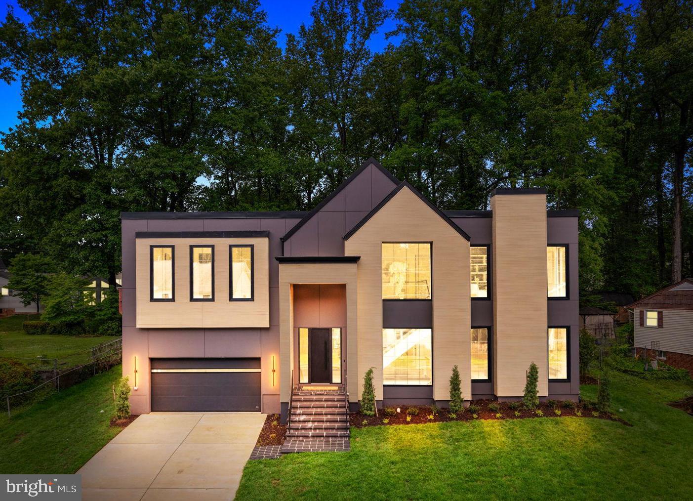 Welcome to this newly completed residence, where architectural sophistication meets the warmth of a true home. Custom-crafted by Composition Homes, this residence artfully balances Scandinavian-inspired minimalism with high-end functionality, pairing clean, modern lines with warm and refined materials. Spanning 5,765 total finished square feet in the heart of Vienna, the home makes a striking first impression with its pronounced architectural gables, NewTechWood Japanese Cedar accents, and oversized 8-foot European black tilt-and-turn windows that flood the interior with natural light.
The interior showcases a thoughtful approach to contemporary design, featuring ten-foot ceilings on the main level and a meticulous trimless finish—entirely free of baseboards or window casings—allowing the 7.5-inch wide-plank white oak floors to run seamlessly throughout. Vertical transitions are defined by an open stairwell featuring glass railings and highlighted by stunning sculptural lighting.
The heart of the main level is the gourmet kitchen, where rich walnut meets the muted elegance of matte Verde Comodoro frameless cabinetry. Polished Calacatta Supreme quartzite countertops and professional-grade Bertazzoni appliances including a 36-inch induction cooktop and integrated refrigerator and freezer columns anchor this chef-caliber space. Positioned perfectly off the kitchen, the dining area offers an effortless flow for everything from festive celebrations to quiet evening meals. This space transitions naturally into the living room, which is anchored by a 62-inch linear fireplace set within a custom matte-black mantle, creating a sleek horizontal profile beneath a recessed ceiling with LED accent lighting. The entire open-concept wing is framed by oversized windows offering expansive views of the outdoors, where a rear-covered deck with TimberTech composite flooring, pre-wired for ceiling heaters, offers a private, elevated retreat overlooking the grounds. 
Designed for both grand-scale entertaining and functional family living, the home offers six bedrooms and 6.5 bathrooms, including a versatile main-level suite with its own fireplace and full bath that can be used as a home office or a bedroom. 
On the upper level, a spacious loft serves as a sophisticated retreat, complete with built-in bookshelves and a second fireplace that creates an inviting atmosphere for relaxation. The primary suite is a serene sanctuary featuring two custom walk-in closets and an LED accent light channel, while the spa-like primary bath is finished with Maldive quartzite, a freestanding tub, and a large shower with fluted floor-to-ceiling tile. This level also features three additional bedrooms, each offering the privacy of its own en-suite bathroom, along with a dedicated laundry room for effortless daily living.
The expansive lower level is a dedicated destination for wellness and downtime, featuring a tiered media room wired for surround sound and a fitness room with high-impact performance flooring and a private sauna, alongside an additional bedroom and bathroom. The recreation room is defined by a refined wet bar and beverage refrigerator, offering the perfect hub for hosting. Complete with an EV ready garage and situated in the highly rated Madison High School pyramid, this residence offers the perfect balance of luxury living and unmatched convenience.  Located just moments from downtown Vienna, the Mosaic District, the home provides seamless Metro access and a central connection to major corridors for a streamlined commute.