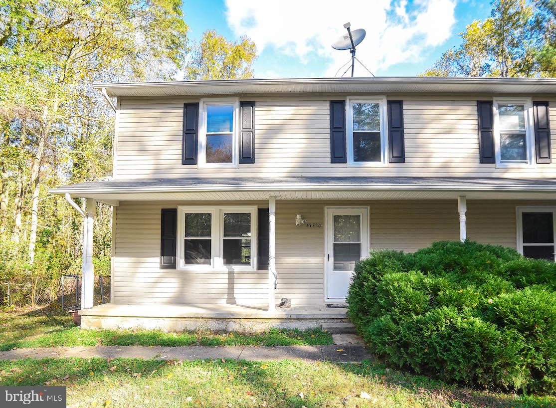 This updated semi-detached home is a great opportunity to stop renting and start owning! 3 bedroom, 1.5 bath, with gorgeous bamboo hardwood flooring and fresh paint throughout. White cabinet kitchen  is open to dining area. Nice size bedrooms and master bedroom has walk-in closet and ceiling fan. Updated bathrooms.   Sit on front porch or enjoy the partially wooded backyard - shade and privacy on almost half an acre!  Siding and windows are five years young and newer HVAC. Auxiliary baseboard heat. Minutes from Gate 3 at PAX and convenient to shopping. Pay less than rent, see this home today!