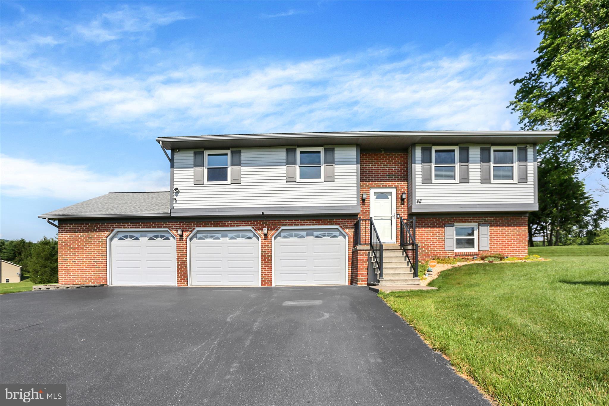 SUPERBLY WELL MAINTAINED BI-LEVEL WITH OVER 2800 SQ FT OF LIVING SPACE. RECENTLY UPDATED KITCHEN AND PRIMARY BATH AND NEWER WINDOWS. KITCHEN FEATURES 5 BURNER GAS RANGE (PROPANE FUELED), REFRIGERATOR, DISHWASHER, AND MICROWAVE. BREAKFAST/DINING AREA LEADS TO A FANTASTIC COMPOSIT DECK WITH BONUS REMOTE AWNING AND WONDERFUL EXSPANSIVE OUTDOOR ENTERTAINMENT AREA WITH LARGE GAZEBO AND REALLY INCREDIBLE BEAUTIFUL  INGROUND POOL AND BATH HOUSE WITH SINK AND TOILET. PERFECT FINISHED LOWER LEVEL W/POWDER RM AND WASHER/DRYER (INCLUDED) AREA FOR ADDITIONAL LIGHT AND BRIGHT LIVING SPACE. (STEREO SPEAKERS ARE HARDWIRED AND CAN STAY) THE 3 CAR GARAGE IS A HUGE BONUS. (ONE ELEC CAR CHARGER INCLUDED) PLENTY OF DESIREABLE STORAGE SPACE. WELL IS LOCATED TO THE RIGHT OF POOL AND SECTIC IS LOCATED LEFT OF HOUSE/POOL. REAR DECK HAS A 16 X 18 SECTION (AWNING AREA) AN 8 X8 STEP DOWN LEADING TO THE 13 X 18 COVERED GAZEBO. SECURITY SYSTEM CAN BE OPTED BY NEW OWNER, THERE IS A FILTER FOR DRINKING WATER AND A RADON SYSTEM. THERE ARE GREAT VIEWS! SOLAR PANELS ARE OWNED AND TRANSFER WITH NO FEE. ADDITIONAL POOL FEATURES AS FOLLOWS: 16 X 32 CRYSTAL POOL WITH L SHAPED SECTION EXPANDING TO 24 FT FEATURES A PASSIVE UNIQUE WATER PIPE GRAVITY SYSTEM FOR ADDITIONAL POOL HEATING. IF DESIRED CAN USE HEAT PUMP TO HEAT POOL AS WELL. THE POOL TEMP ON JUNE 11TH WAS 89 DEGREES. EQUIPMENT INCLUDES A SOLAR COVER AND POOL REBOT. A LOVELY SETTING AND A PLEASURE TO INSPECT!