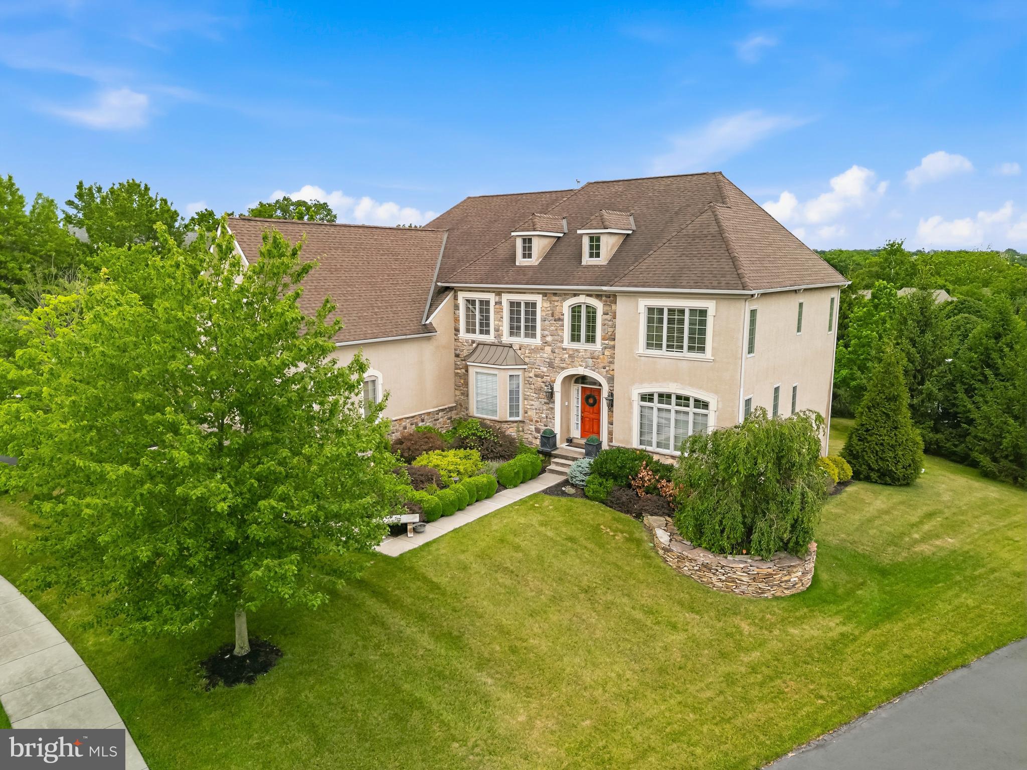 Experience luxury living in one of Harleysville's most prestigious communities built by the exceptional Guidi Custom Homes. Situated on a beautiful private lot, this stunning residence combines elegant design, expansive living spaces, and a highly desirable walk out professionally finished lower level creating the perfect setting for entertaining, relaxation, and everyday comfort. High end finishes and architectural details throughout this  expertly crafted home. Abundant natural light from oversized windows  in every room. Gourmet kitchen  with beautiful white cabinetry ,large island,  large pantry,  coffee station, designed for everyday and entertaining.  Spacious eat in kitchen overlooking the back yard.  Grand family room open to kitchen area with wood burning stone  fireplace and soaring ceiling. Elegant dining room , living room and home office complete the first floor.  The spacious primary suite is a true retreat with walk in closets, a  separate sitting room, bath room with double sinks, soaking tub and large shower. Secondary bedrooms are well sized. Two additional full bathrooms on this level. From the second floor there is a staircase leading to a third level that is currently unfinished but could be finished  as a bedroom with bathroom or used as a playroom etc. The lower level walkout basement is smartly finished with rooms for every interest. The bar area with seating is certainly a standout.  Game room, movie room, gym, and full bathroom make it very flexible living space. the walkout leads to a large patio.  Make this gorgeous home your own!