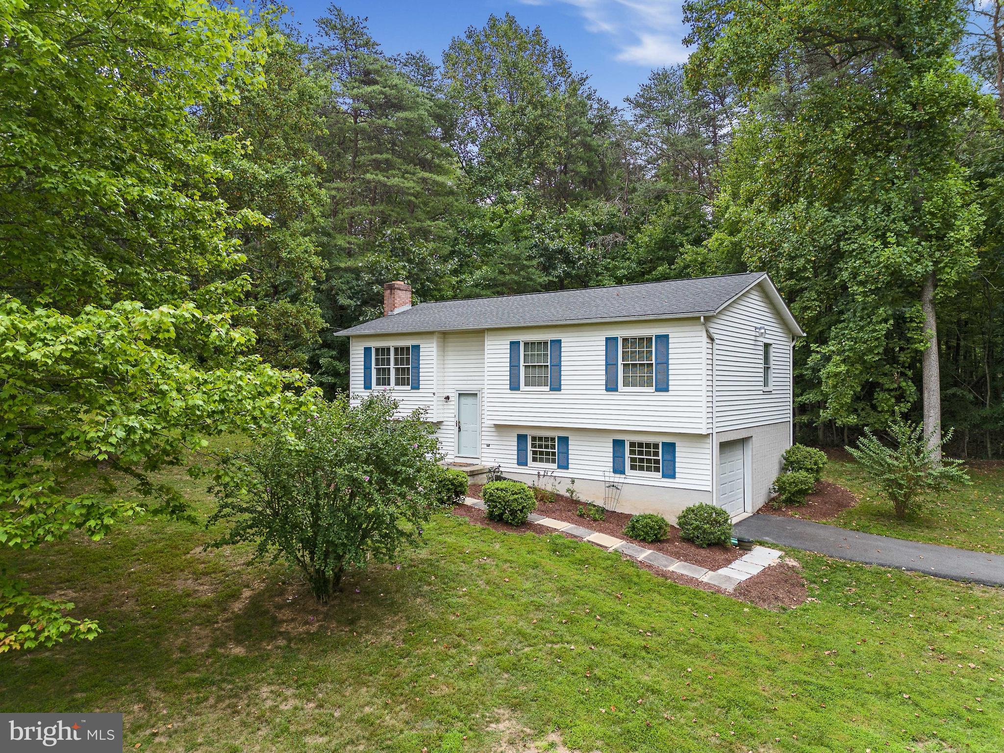 Embrace the outdoors with this exceptional opportunity to own your own piece of paradise – over 12 acres of breathtaking beauty in Jefferson County, WV! Whether you're yearning for serene woodland living or envisioning the perfect spot for an additional new house elsewhere on this expansive property (subject to county approval), this is your chance to make dreams come true.

Welcome to a charming 2-bedroom, 1-bath home that boasts a unique blend of comfort and natural wonder. This one-owner gem comes complete with a one-car garage, a spacious eat-in kitchen that's ready to host gatherings, and a living room adorned with gorgeous hardwood floors that bring the outdoors in.

As you explore, you'll uncover two cozy bedrooms designed for convenience. The care and love poured into this home are evident throughout, making it a true haven to call your own.

Venturing downstairs, a world of possibilities awaits. A recreation room with a wood-burning fireplace is the perfect spot to unwind after a day of outdoor adventures. A generously sized laundry and storage area add practicality to the mix, while direct garage access ensures convenience is at your fingertips.

Fresh paint and new flooring breathe new life into every corner, creating a canvas that's ready for your personal touch. Step outside to your own private deck, an idyllic setting to savor morning coffees or evening sunsets in peaceful seclusion.

Nestled just a stone's throw away from the Virginia state line, you'll relish the utmost privacy in this hidden retreat. This is more than a home – it's a gateway to a life enriched by the great outdoors. Don't let this exceptional opportunity slip away – schedule your showing today and discover the endless possibilities that await!