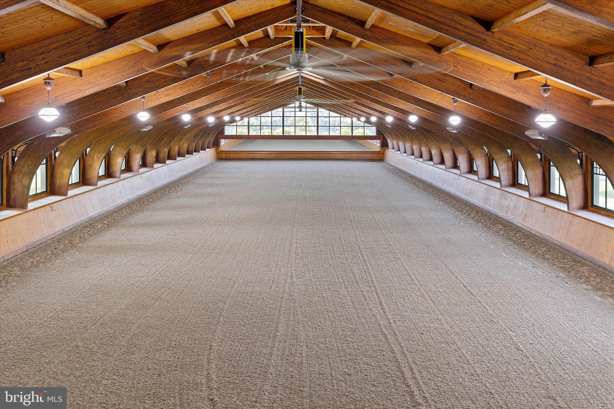 Rarely… does such a unique, well-designed, constructed, and maintained world-class equestrian facility grace the international real estate market. Spanning 510 preserved acres, this iconic equestrian estate boasts a rich legacy and unparalleled amenities, including a state-of-the-art equestrian training facility built by B&D Builders, a nationally renowned custom builder. RiverEdge Farm is synonymous with world-class equestrian training, ideally suited to any discipline. The farm has previously housed numerous Olympic dressage and three-day event horses, operated as a top-class private thoroughbred breeding facility, and most recently served as a training mecca for world-class dressage. At the heart of the property is a spectacular 31-stall, 45,000-square-foot indoor dressage show barn. Built with unmatched craftsmanship and old-world charm second to none. Visitors are welcomed through a charming, covered porch and elegant, glass-paneled double doors into a grand reception area featuring a central stone fireplace and a private meeting room, all adorned with custom millwork throughout. Overlooking the 100’ x 200’ indoor dressage arena are stunning glass-enclosed observation areas on both the first and second floors, that are brilliantly filled with natural light and character. This impressive space includes twin service bars, a conveniently located commercial-grade kitchen, and a spacious area ideal for entertaining. An ornate wide-plank staircase leads to a lofted second level with private office suites, an exercise room, and a lounge area. The barn itself is thoughtfully designed, featuring barreled ceilings, six grooming/wash stalls, two well-appointed tack rooms, a central eat-in kitchen/break area, a laundry room, and a three-season sitting room offering panoramic views through grand window walls on two sides. The barn’s layout seamlessly flows through a bank of 31 spacious (mostly 14’ x 14’) stalls, curving into an additional wing with even more accommodations. Complementing the equestrian facilities is a beautifully appointed 9,000-square-foot brick manor home of Georgian architectural style, offering four bedrooms and 3 full & 2 half bathrooms. This wonderful home features an updated kitchen, brick and antique wood flooring, beamed ceilings, a sunken living room, multiple fireplaces, a spacious game room, and a detached three-car garage. The extensive grounds are thoughtfully and professionally landscaped. It artfully blends traditional character with modern conveniences—perfectly suited for today’s lifestyle. Also included within this breathtaking property is a luxurious guest home featuring a chef’s kitchen and an enclosed timber-framed pavilion over a heated indoor pool. Additionally, there is a 15-stall center-aisle block barn with a six-horse Kraft Eurocizer, as well as numerous ancillary operational buildings, including a fully functional brick office building—and numerous double-fenced fields and paddocks with approximately 10 miles of four-rail post-and-board fencing offering unparalleled views throughout the farm. RiverEdge is set within one of Maryland’s largest agricultural preservation areas and is protected by a conservation easement, ensuring its beauty and legacy for generations to come. The property includes 4 parcels: 0802016206 - 109.4 acres, 0802019078 - 186.7 acres, 0802029049 - 106 acres, and 0802029537 - 109.4 acres.