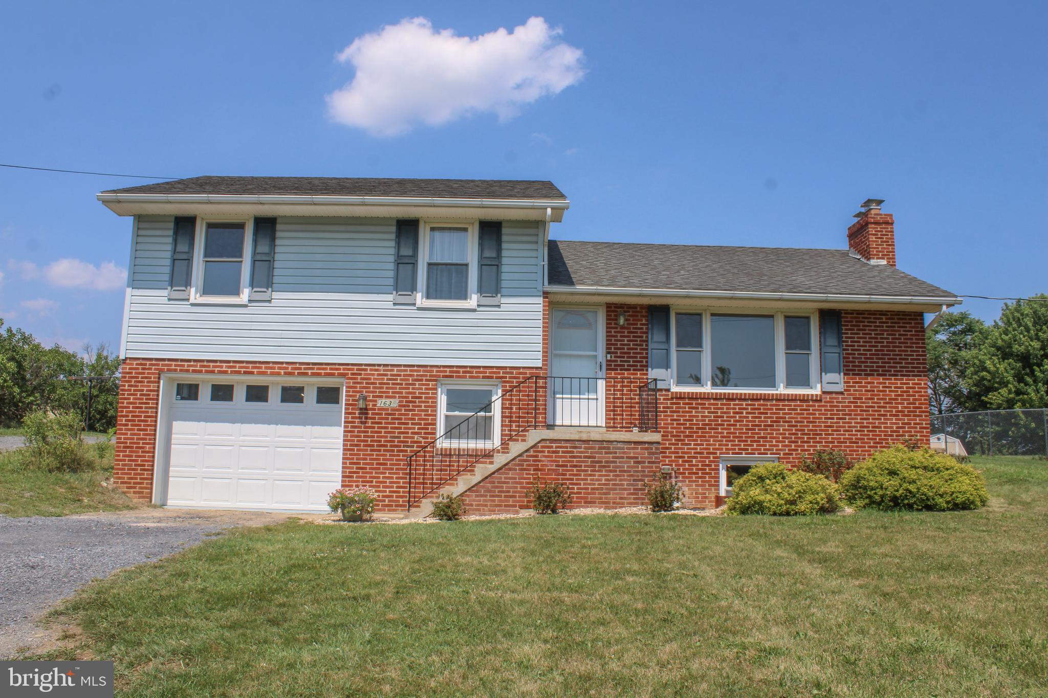 Conveniently located near I-81 and Route 11, this spacious split-level home offers comfort, character, and plenty of room to grow.  Beautiful hardwood flooring extends throughout most of the home, while the inviting living room features a classic white brick fireplace with gas logs.  The dining area and kitchen showcase solid pine cabinetry complemented by updated countertops, creating a warm and functional gathering space.  A side patio offers a space to sit and enjoy the outdoors.  The upper level includes three bedrooms, all with hardwood floors and a beautifully updated & tiled bath w/shower. On the middle level, you'll find a full bath with laundry area, including a washer and dryer that convey, along with a separate office space ideal for working from home. The lower basement level offers over 500 square feet of additional space, complete with a wood stove and ready for your finishing touches. A one-car garage provides extra room for a freezer, workbench, or storage. Situated on a large, deep lot, the property offers ample parking and includes both a wood shed and a storage shed, providing plenty of space for tools, equipment, and outdoor essentials.  Broker related.