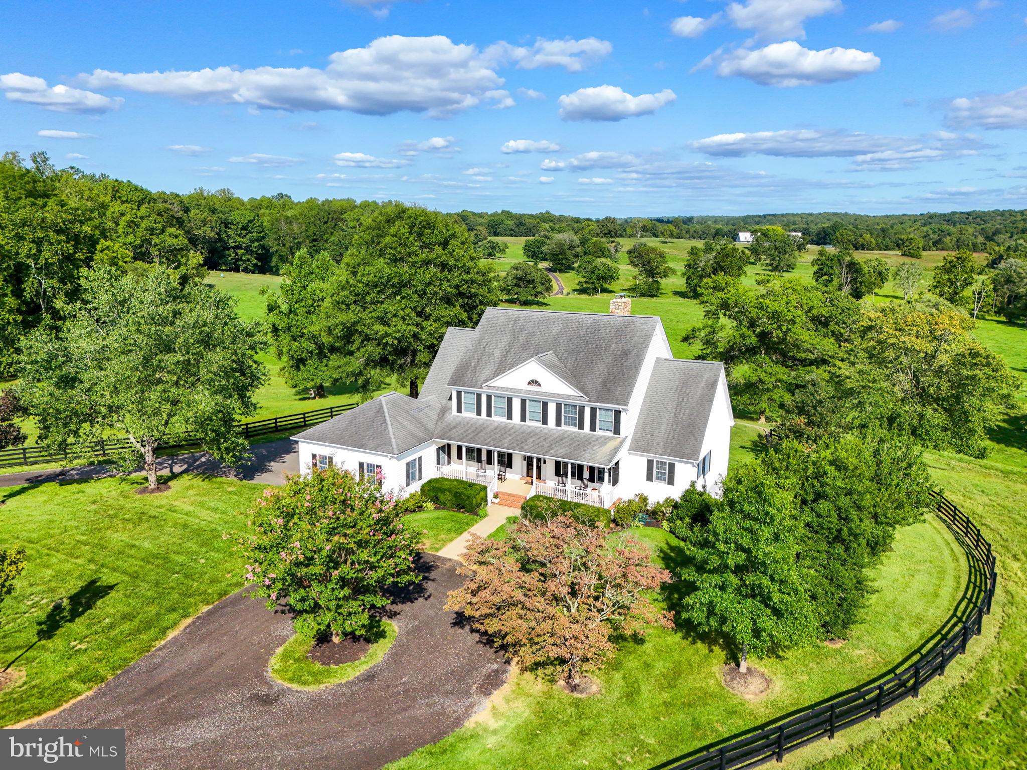 Own your piece of Virginia Horse and Wine Country living,  just a few short minutes away from energetic downtown Warrenton and thriving Northern Virginia. This property is offered for the first time to its new family! Located in  Castle Welch Farms, this has a total of 6 total lots and homes with idyllic serene landscapes that overlook the beautiful mountain side and pastoral views. This 51 acre parcel contains everything one could desire of the land. The Great Run tributary has 978 feet of frontage and accessible on the property. The colonial style farmhouse is enchanting with a full sized covered porch, perfect for watching sunsets with a cold beverage. Entry way foyer is traditionally flanked by a formal dining room to the left and office/den on the right. The views of the gorgeous countryside can be seen directly from the main entryway though the newer energy efficient windows. Family room has a two story ceiling with the bold focal point being the stone floor to ceiling fireplace. Built-in solid walnut wood book shelves make for a perfect storage solution for family games, artwork and keepsakes.  The kitchen has been recently updated to feature granite counter tops and island, newer cabinetry, and stainless appliances. Plenty of room for an eat in kitchen as the bright and sunny bump out is perfect for the whole family to gather. One of two laundry areas can be found on the main level as well as a large owners suite with large luxury owners bathroom. Access to the no maintenance deck can be access via the primary and the family room areas. Entertainers dream back yard space with flat prime space perfect for infinity edge pool that would look onto existing 2 acres stocked fishing pond and a peaceful landscape. Upper level offers hardwood flooring as well as 3 large bedrooms and a Jack and Jill Bathroom. Lots of storage space throughout! Fully finished basement has large entertaining space with bar,  fireplace, full bathroom, and flex space for bedroom or other use. Kitchenette area is fully functional in basement  along with the second washer and dryer spaces! French doors from walk out basement leads to large paver patio. Owned propane tank on site which fuels the whole house generator that will surely come into good use for those rare power outage events. The outbuildings on this property include multiple sheds, barns, and fenced in areas to keep the livestock corralled.  90 x 42 foot Morton metal building/barn can easily be converted to horse stables, includes an office, tack room and restroom. Shop space on site is 40 x 36 with two 16 x 11 garage doors this also has storage loft. Additional 40 x 16 lean to located on the back side of the shop. Very close to Fauquier Springs Country Club , wineries, breweries, and markets. You won't want to miss the opportunities this home provides! Schedule your tours today!
