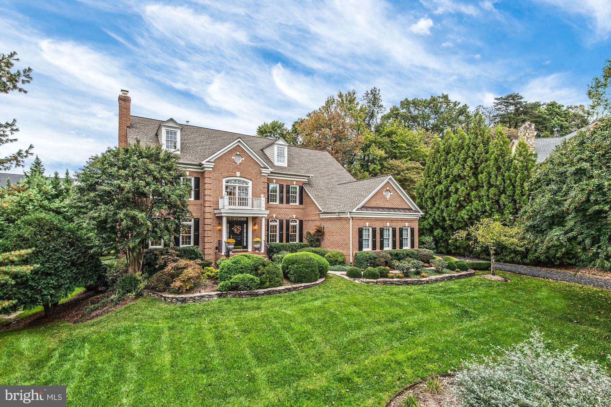 Light-filled brick colonial with a lush and private setting featuring a two story foyer, family room with a gas fireplace and vaulted ceilings, gourmet kitchen with Viking appliances and breakfast area, an expansive master suite, a recreation room with a billiards area, a large deck overlooking the backyard and a three-car garage.
