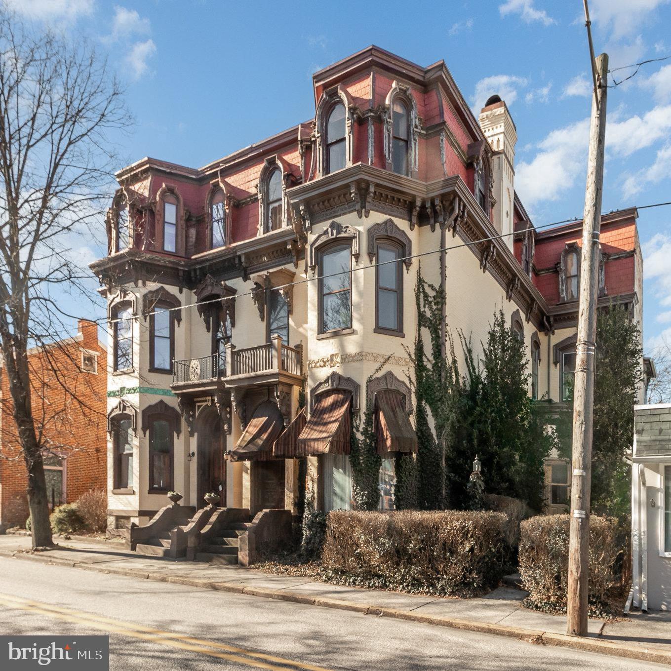 This home is a piece of history just waiting for someone to restore it to it's former splendor!  Potential is abundant.  Impressive entry from vestibule into foyer leads to grand staircase with original wood railing and spindles.  You will find substantial baseboards, crown molding, and high ceilings throughout.  Most rooms have closets that are recessed into the walls. Hand-crafted wood work is everywhere.  First floor with half bath was converted to offices for a dental practice. The visionary buyer could restore it back to its original glory from an earlier era...or update and use as a flex space for future income.  2nd and 3rd floors include kitchen, dining room, laundry, 4 bedrooms, 2 full baths plus a bonus room.  There is an outside entrance that currently exists to these floors, however the stairs would need to be replaced. The large detached oversized garage offers inside parking for at least  3-4 cars, storage space, plus a large room above the main area of the garage that could be finished as living space or additional storage. There is an old wall length pipe radiator that was used to keep horses warm in the bygone days when this was a carriage house! Bring your vision and creativity and transform this home to it's original grandeur.