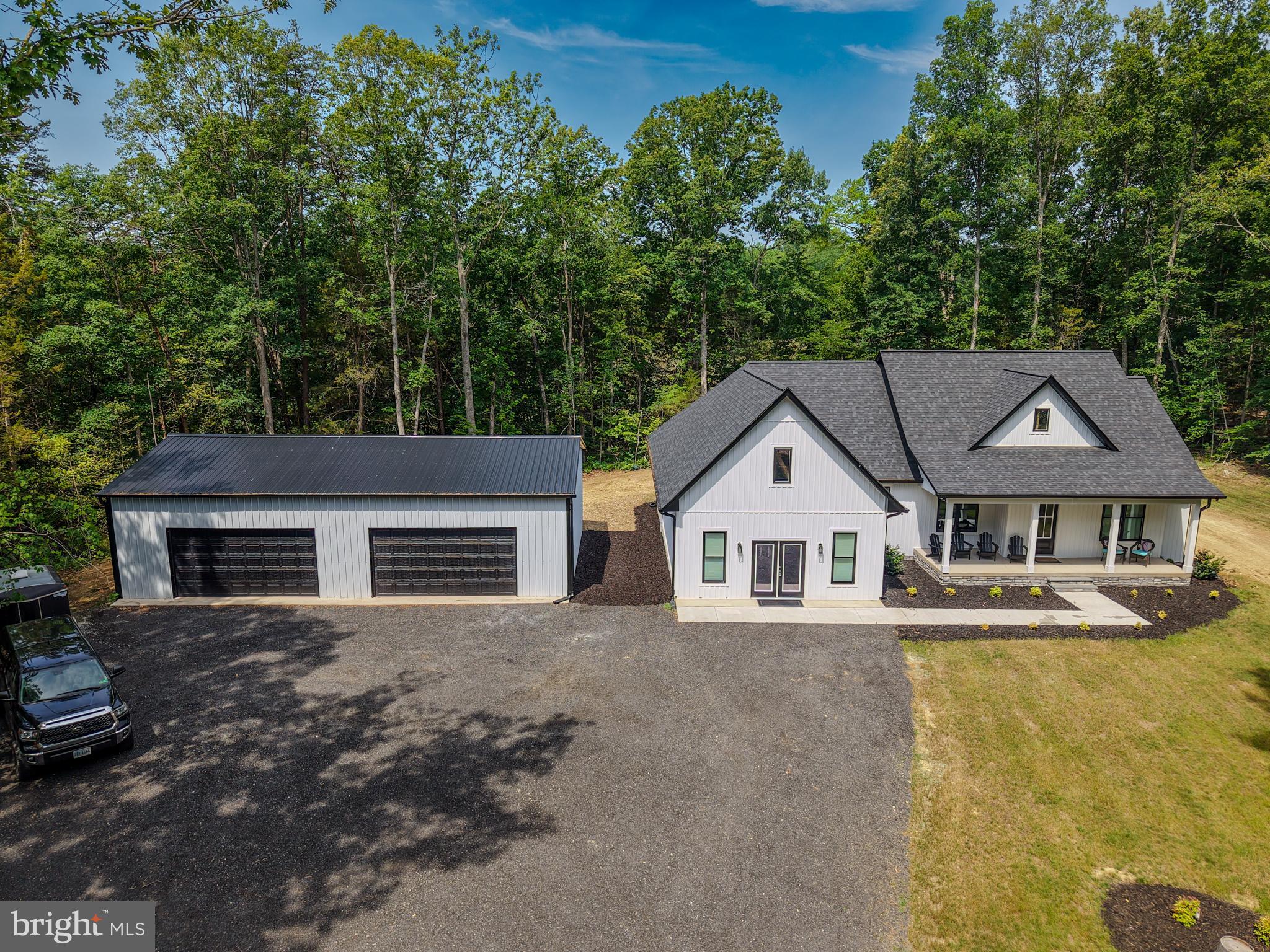 Situated in a peaceful rural setting in Unionville, this custom modern farmhouse rancher offers the perfect combination of upscale living and countryside charm. Privately tucked behind a gated driveway and backing to picturesque undeveloped farmland, this exceptional property delivers the privacy and serenity so many buyers are searching for.

Inside, you’ll find over 2,500 square feet of beautifully finished living space featuring 4 bedrooms and 2 full baths with a bright, open-concept layout designed for both everyday comfort and entertaining. The home is filled with stylish modern touches including upgraded lighting, granite countertops, sleek finishes, and quality appliances that complement the farmhouse-inspired design. A spacious bonus room adds flexibility for a media room, home office, fitness space, or guest area.

Outdoor living is just as impressive with inviting covered front and rear porches that create the ideal setting to relax and enjoy the surrounding countryside. The meticulously landscaped grounds enhance the property’s curb appeal, while the massive 1,500 square foot detached garage offers abundant space for vehicles, equipment, hobbies, or additional storage.

Whether you’re looking for a private retreat, space to spread out, or a move-in ready home with modern style and rural beauty, 26340 Old Mill Road offers a rare opportunity to enjoy refined country living at its finest.