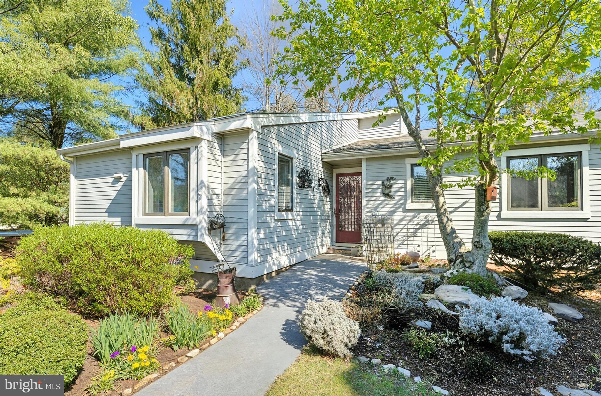 Welcome to 754 Inverness Drive, a beautifully maintained Donegal model end unit located in the sought-after Hershey’s Mill community. This 2-bedroom, 2-bathroom home exudes charm and comfort, with thoughtful updates and inviting spaces both inside and out. As you approach, you’ll be greeted by stunning English perennial gardens framing both the front and private back patio. Step into the foyer, where a full-sized coat closet offers convenience before leading you to a bright, southern-facing kitchen. Recently refreshed with freshly painted cabinets and  stainless steel appliances, the kitchen is also equipped with a utility closet housing a stacked washer/dryer and space for recycling bins. New wood-plank flooring flows throughout the home, adding warmth and style. The light filled dining and living areas are both elegant and welcoming, featuring a cozy wood-burning fireplace. Sliding glass doors open to the private patio, a serene retreat adorned with custom wooden planters and surrounded by trellises—perfect for enjoying your morning coffee or an evening glass of wine. The patio houses an exterior closet for gardening equipment. Down the hall, you’ll find a modern second bathroom and a versatile second bedroom. This room has been extended into the closet space but can easily be retrofitted to its original layout with the included doors stored in the basement. The main bedroom suite is a true sanctuary, boasting a spacious walk-in closet and an updated bathroom with a walk-in shower and linen closet. The newly insulated attic can be accessed from the walk-in closet. The unfinished basement, with its high ceilings, provides ample storage opportunities, including floor-to-ceiling storage racks. Additionally, the property has a large detached garage, new roofs and siding in 2024/2025, ensuring peace of mind for years to come.  
Hershey's Mill; a gated, security managed community has so much to offer its residents from the club house, two community homes that can be leased for large events; swimming pool, pickleball court, tennis court, wood shop and garden areas which can be available and so much more! The Golf Course is an extra fee, social memberships are also available.  
The property has been emptied, allowing you to walk into a blank canvas and envisioning this truly remarkable place as your own. Don't miss the chance to make this exceptional home yours!