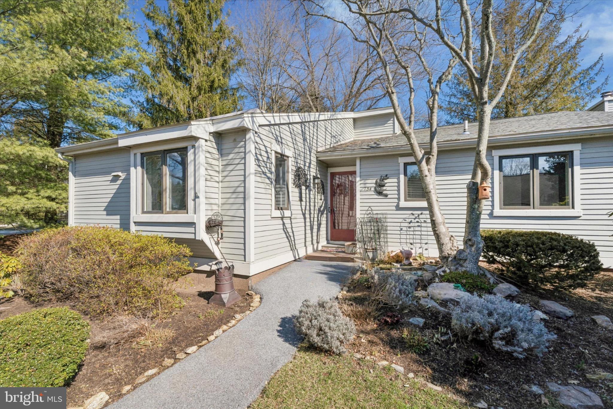 Welcome to 754 Inverness Drive, a beautifully maintained Donegal model end unit located in the sought-after Hershey’s Mill community. This 2-bedroom, 2-bathroom home exudes charm and comfort, with thoughtful updates and inviting spaces both inside and out. As you approach, you’ll be greeted by stunning English perennial gardens framing both the front and private back patio. Step into the foyer, where a full-sized coat closet offers convenience before leading you to a bright, southern-facing kitchen. Recently refreshed with freshly painted cabinets and  stainless steel appliances, the kitchen is also equipped with a utility closet housing a stacked washer/dryer and space for recycling bins. New wood-plank flooring flows throughout the home, adding warmth and style. The light filled dining and living areas are both elegant and welcoming, featuring a cozy wood-burning fireplace. Sliding glass doors open to the private patio, a serene retreat adorned with custom wooden planters and surrounded by trellises—perfect for enjoying your morning coffee or an evening glass of wine. The patio houses an exterior closet for gardening equipment. Down the hall, you’ll find a modern second bathroom and a versatile second bedroom. This room has been extended into the closet space but can easily be retrofitted to its original layout with the included doors stored in the basement. The main bedroom suite is a true sanctuary, boasting a spacious walk-in closet and an updated bathroom with a walk-in shower and linen closet. The newly insulated attic can be accessed from the walk-in closet. The unfinished basement, with its high ceilings, provides ample storage opportunities, including floor-to-ceiling storage racks. Additionally, the property has a large detached garage, new roofs and siding in 2024/2025, ensuring peace of mind for years to come.  
Hershey's Mill; a gated, security managed community has so much to offer its residents from the club house, two community homes that can be leased for large events; swimming pool, pickleball court, tennis court, wood shop and garden areas which can be available and so much more! The Golf Course is an extra fee, social memberships are also available.  
The property has been emptied, allowing you to walk into a blank canvas and envisioning this truly remarkable place as your own. Don't miss the chance to make this exceptional home yours!