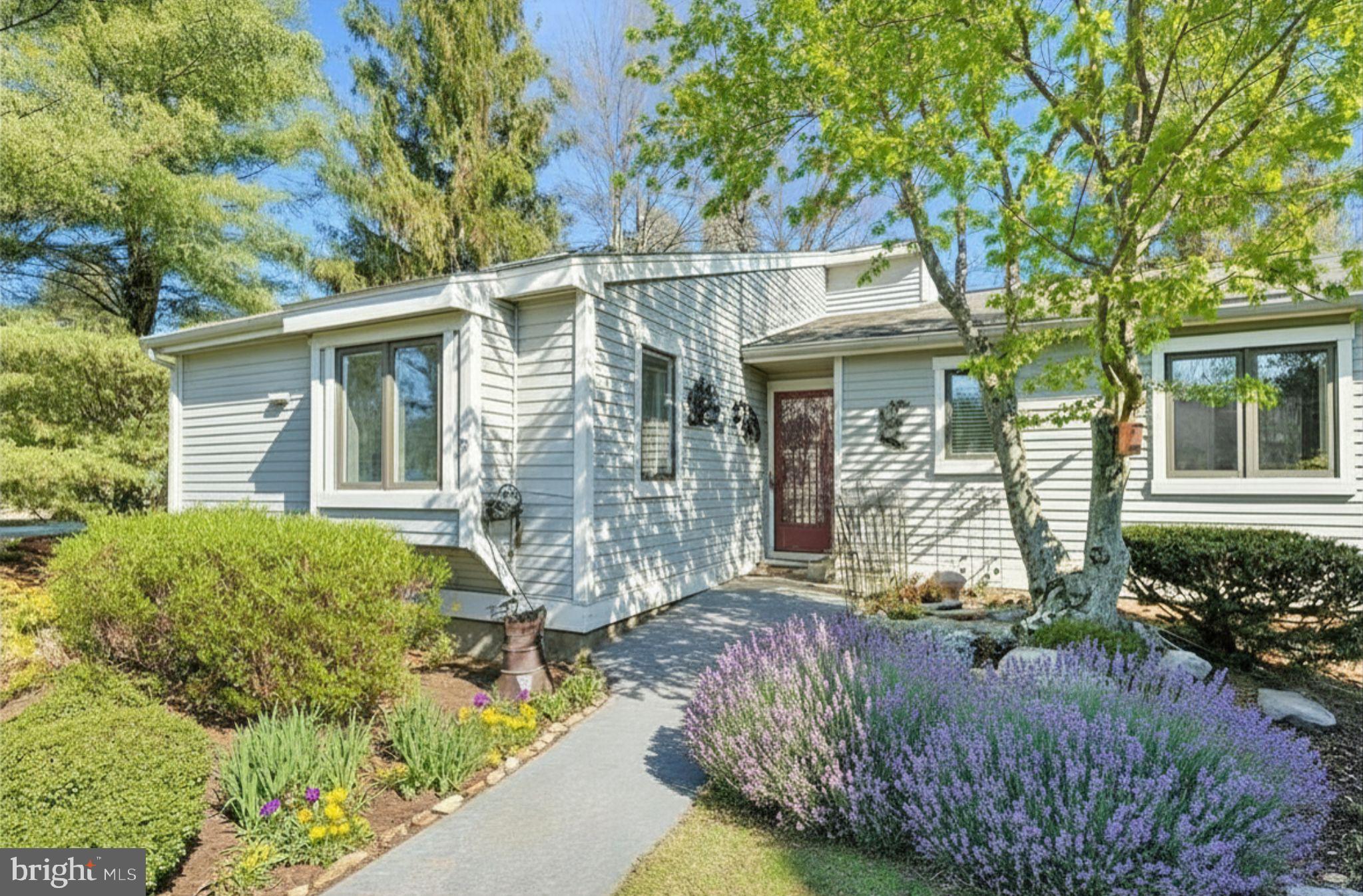 Welcome to 754 Inverness Drive, a beautifully maintained Donegal model end unit located in the sought-after Hershey’s Mill community. This 2-bedroom, 2-bathroom home exudes charm and comfort, with thoughtful updates and inviting spaces both inside and out. As you approach, you’ll be greeted by stunning English perennial gardens framing both the front and private back patio. Step into the foyer, where a full-sized coat closet offers convenience before leading you to a bright, southern-facing kitchen. Recently refreshed with freshly painted cabinets and  stainless steel appliances, the kitchen is also equipped with a utility closet housing a stacked washer/dryer and space for recycling bins. New wood-plank flooring flows throughout the home, adding warmth and style. The light filled dining and living areas are both elegant and welcoming, featuring a cozy wood-burning fireplace. Sliding glass doors open to the private patio, a serene retreat adorned with custom wooden planters and surrounded by trellises—perfect for enjoying your morning coffee or an evening glass of wine. The patio houses an exterior closet for gardening equipment. Down the hall, you’ll find a modern second bathroom and a versatile second bedroom. This room has been extended into the closet space but can easily be retrofitted to its original layout with the included doors stored in the basement. The main bedroom suite is a true sanctuary, boasting a spacious walk-in closet and an updated bathroom with a walk-in shower and linen closet. The newly insulated attic can be accessed from the walk-in closet. The unfinished basement, with its high ceilings, provides ample storage opportunities, including floor-to-ceiling storage racks. Additionally, the property has a large detached garage, new roofs and siding in 2024/2025, ensuring peace of mind for years to come.  
Hershey's Mill; a gated, security managed community has so much to offer its residents from the club house, two community homes that can be leased for large events; swimming pool, pickleball court, tennis court, wood shop and garden areas which can be available and so much more! The Golf Course is an extra fee, social memberships are also available.  
The property has been emptied, allowing you to walk into a blank canvas and envisioning this truly remarkable place as your own. Don't miss the chance to make this exceptional home yours!