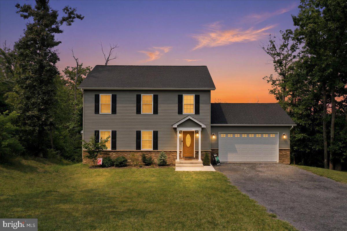 Welcome home to this like-new retreat nestled on just over an acre with breathtaking mountain views, the perfect blend of peaceful country living and everyday convenience. Located just 10 minutes from town and only minutes to I-81 and other major commuter routes, this home offers the best of both worlds. Step inside to luxury vinyl plank flooring throughout and an open-concept layout designed for both comfortable living and entertaining. The spacious kitchen features granite countertops, stainless steel appliances, abundant cabinetry, and overlooks the dining and family room, creating the ideal gathering space. Step out onto the rear deck and enjoy your morning coffee while taking in the incredible mountain views and watching wildlife in your fully fenced backyard. Want an even more expansive view? Trim a few trees and unlock an even more stunning mountain backdrop. Upstairs, the light-filled primary suite offers a private and relaxing retreat, while two additional bedrooms and a full hall bath provide plenty of room for family, guests, or a home office. The walkout basement is ready for your personal touch with a rough-in for a future bathroom, offering endless possibilities to expand your living space. Additional highlights include an oversized two-car garage and an upgraded water filtration system. As an added bonus, residents enjoy exclusive access to the community lake, perfect for fishing, boating, or simply enjoying the outdoors. Situated on a paved road in a scenic setting, this home offers the space, views, and lifestyle you've been searching for without sacrificing convenience. Don't miss your opportunity to make this beautiful property your own. Schedule your private tour today!