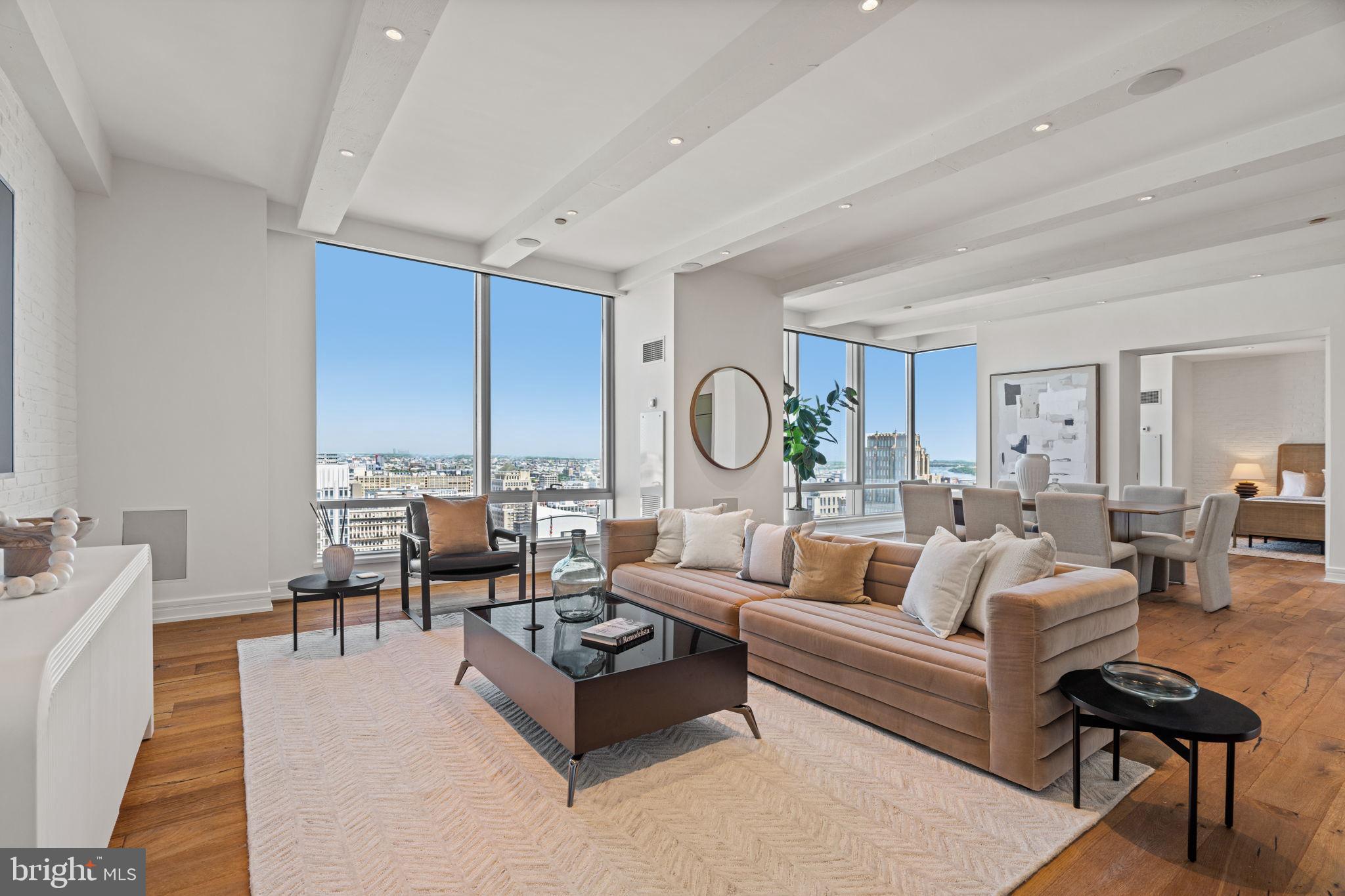 This expansive and extensively upgraded three bedroom, four and a half bathroom residence offers over 3,000 square feet of beautifully designed living space with breathtaking views of City Hall, Dilworth Park, and the Philadelphia skyline. A gracious foyer opens into expansive living, dining, and entertaining spaces framed by dramatic walls of windows that flood the home with natural light. Thoughtfully renovated throughout, the residence blends refined finishes with a warm, modern aesthetic, featuring wide plank flooring, layered textures, and custom design details. The beautifully appointed kitchen showcases custom cabinetry, marble countertops, premium appliances, and a large center island with seating. Privately situated within the home, the primary suite serves as a tranquil retreat, offering exceptional scale and comfort. The lavish walk-in dressing room features custom built-ins, abundant storage, and skyline views. The dual primary marble bathrooms have been thoughtfully designed with a sophisticated spa-inspired aesthetic. The additional two bedrooms are generously sized and feature ample closet space and a private en-suite bathroom. One car GARAGE PARKING and an impressive collection of upgrades, including smart lighting controls and motorized window treatments, complete this exceptional residence. Association fees include a 24/7 concierge, chauffeur driven car service, state of the art fitness center, pool with hot tub, and residents' lounge with an outdoor terrace. Perfectly situated in the Rittenhouse Square and Avenue of the Arts area, this premier residence is just steps from fine dining, world renowned cultural destinations, exclusive shopping, exciting nightlife, highly acclaimed hospitals, and major transportation. 
A second parking space is available for an additional fee.