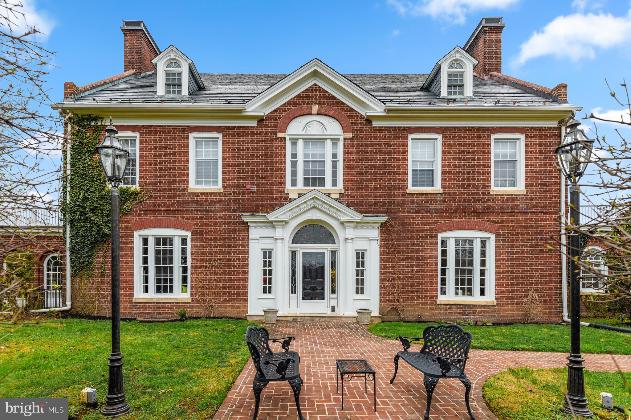 Step inside a timeless masterpiece.

Be just the fourth owner of this historic mansion, designed by noted architects Wilson Levering Smith and Lawrence Fowler. It was commissioned and built following the marriage of the heirs of two prominent Baltimore families.

Completed circa 1914, the home has been meticulously restored and enhanced by its current owners. The heavy lifting has all been done. The next owners get to move in and live their Georgian Revival fantasy!

Major recent upgrades to the property include the complete renovation of the heated swimming pool, including all new equipment: heater, lights, electric, gas line, coping, tile, and pool deck.

Enter into the expansive center hall and let your eyes wander up the wide, spiraling staircase. To your left is a formal living room like no other. Designed by Pascale de Fouchier of PDF Interiors, the space is a livable showpiece. It is accented by elaborate crown molding and features a working wood-burning fireplace. It leads into the massive, gorgeous sunroom with its surrounding arched windows.

There will be room for all of your guests and their guests in your dining room. With its soaring ceiling and moldings, yours will be the dinner parties that friends can't wait to attend. The butler's pantry with restored original cabinetry is a dramatic gem that transitions into your light-filled, dream kitchen.

The kitchen and butler's pantry have been fully renovated, with high-end appliances featuring a chef-grade Blue Star stove, top line Miele dishwasher, GE Profile built-in refrigerator, Uline beverage center, and Hoshizacki professional grade ice maker cabinet.

The owners have installed Reico Design Line custom cabinetry, added a built-in banquet, a hidden broom closet, Carrara marble countertops, and reverse osmosis water filtration.

Upstairs will be your oasis. The gracious primary suite features a dressing room and a balcony. The three additional second-floor bedrooms are light-filled and large, with two more full baths. The top or third level features an additional four bedrooms, two full baths, and a bonus room.

Other major projects completed by the current owners include restoration of the windows, four bathroom remodels, remediation of lead paint and asbestos, substantial plumbing and electrical work, restoration of the living room fireplace and chimney repairs, addition of Coretec Plus 7" Midway oak flooring, moving the washer and dryer upstairs and more. A full list of renovations and upgrades is available in the disclosures.

Tucked away inside Woodholme Reserve but not part of the HOA, this historic grand dame is an elegant and sophisticated capsule of the Progressive Era.