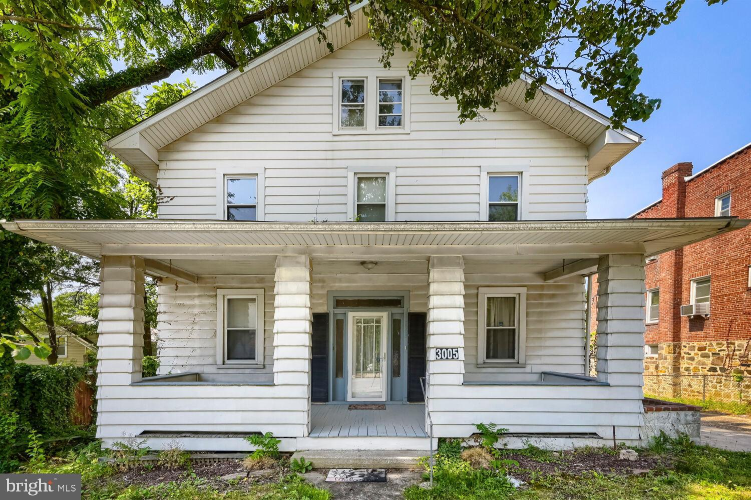 Solid, updated home in Lauraville — steadily on the rise for over a decade — offering over 2,200 sq ft of living space across three finished levels (see attached floor plan). 5 bedrooms and 2 full baths with room to spread out. Hardwood floors and generously sized rooms run throughout, including big closets and a main-level bedroom and full bath for one-level living or a guest suite. The kitchen and flooring have been updated, and the living room features a brick fireplace. Upstairs offers three more bedrooms and a second kitchen, and a fully finished third floor — not reflected in the city's square footage record, see attached floor plan — adds a huge bonus room ideal for a rec room, home office, or extra living space. The basement includes a workshop area and plenty of storage, with more potential to finish. The owner used this home as two units for nearly 50 years, though it's not zoned for multi-unit use — a buyer could bring back that same flexibility for an in-law setup, multigenerational living, Airbnb potential, or simply renting out a room to a roommate. A covered front porch, second-floor deck, driveway, and detached 2-car garage round it out. Recent big-ticket updates include a new main roof (2020), new garage roof (2025), and new electrical breaker panel (2025). Lauraville brings tree-lined streets, a walkable Main Street of local shops and restaurants, and Herring Run Park nearby — a well-established, increasingly desirable corner of the city.