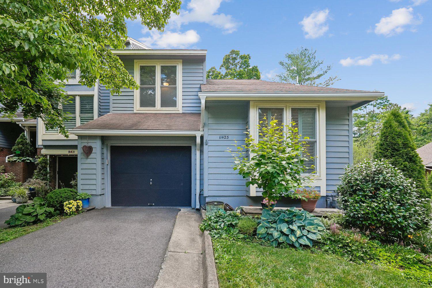Arguably one of the finest addresses in Orchard Green Cluster, this end-unit, three-bedroom residence commands a serene backdrop of open green common space—What unfolds behind the front door a two-story foyer and a home transformed, where no surface, system, or finish has been overlooked.

A completely reimagined eat-in kitchen defines the heart of the home: handmade custom cabinetry, high-end quartz countertops, and stainless steel appliances compose a space that is both quality and subtly contemporary. Throughout the home, recessed lighting or bespoke lighting with dimmers casts a soft, intentional glow, while plantation shutters provide privacy.

The primary bath has been fully renovated with thoughtful precision—a half-wall in the shower provides seclusion, while a custom vanity balances function and form. The second bath  has also been completely redone, and the powder rooms feature tile for clean, sophistication.

California Closets brings curated organization to almost every closet in the home. The home has been insulated and its ducts sealed for superior efficiency, while the HVAC system—complete with humidifier and ultraviolet light purification—ensures immaculate air quality. A whole-house water filtration system, and updated electrical throughout (including a replaced breaker box and wiring) complete the meticulous mechanical overhaul.

Outside, slate has replaced the concrete walkway; stepping stones, lavender and hydrangeas mark the property line; a remodeled front porch and a Trex deck complete the outdoor ambiance.  The garage is a masterwork of its own—epoxy floor, custom shelving, and a new opener.

Steps from Lake Anne Plaza, with its Saturday farmers market, and locally owned restaurants. Minutes to Reston Town Center which offers concerts, dining, shopping. Two Silver Line Metro stations provide effortless access to Dulles Airport and downtown D.C., while Reston’s trails, lakes, community pools, and endless seasonal programming invite you into a lifestyle that is as active as it is connected.