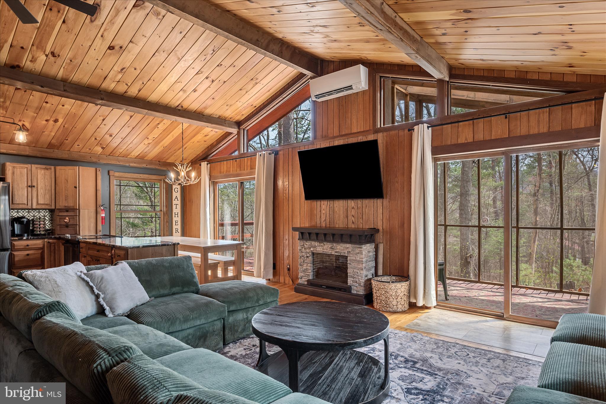 Nestled in the scenic Shenandoah Mountains and located within the four-season Bryce Resort community, this charming two-level ranch-style home offers the perfect blend of mountain serenity and resort living. Warm hardwood floors, walls, and ceilings, along with four electric fireplaces, create a cozy cabin ambiance throughout the home.  You will appreciate distinctive touches found throughout the home that makes this home one of a kind.
The beautifully appointed kitchen features granite countertops, stainless steel appliances, abundant cabinetry with soft-close drawers and doors.  The open-concept main level flows seamlessly from the kitchen and family room to the deck and screened porch, making indoor-outdoor gatherings effortless. Two generously sized bedrooms on the main level provide convenient one-level living, while the full bath showcases a unique copper soaking tub and handcrafted vanity.
The fully finished walkout lower level is filled with natural light and offers an expansive family room, two additional large bedrooms, and a full bath with a newly tiled shower—perfect for hosting while providing added privacy.
Outdoor living is equally inviting, with two levels of decking and a screened porch overlooking the peaceful wooded setting. Major updates have already been completed, including a new roof, attic fan, and two mini-split systems; custom windows  (2017); continuous tankless water heater, stove, and washer/dryer (2021); refrigerator (2022); designer paint (2024); and new porch screens (2026).
Enjoy year-round recreation at Bryce Resort, featuring skiing, snowboarding, snow tubing, golf, mountain biking, and access to Lake Laura for swimming, fishing, canoeing, paddleboarding, and relaxing on the beach. The community also hosts popular events such as Bryce Fest with live music, food vendors, crafts, and fireworks. Just minutes away, sit under the stars and enjoy the Shenandoah Music Festival in historic Orkney Springs, along with nearby attractions including Shenandoah Caverns, Route 11 Potato Chips, and endless hiking opportunities.
Whether you're seeking a full-time residence, mountain retreat, or vacation rental opportunity, this exceptional property offers the very best of Shenandoah Valley mountain and resort living.