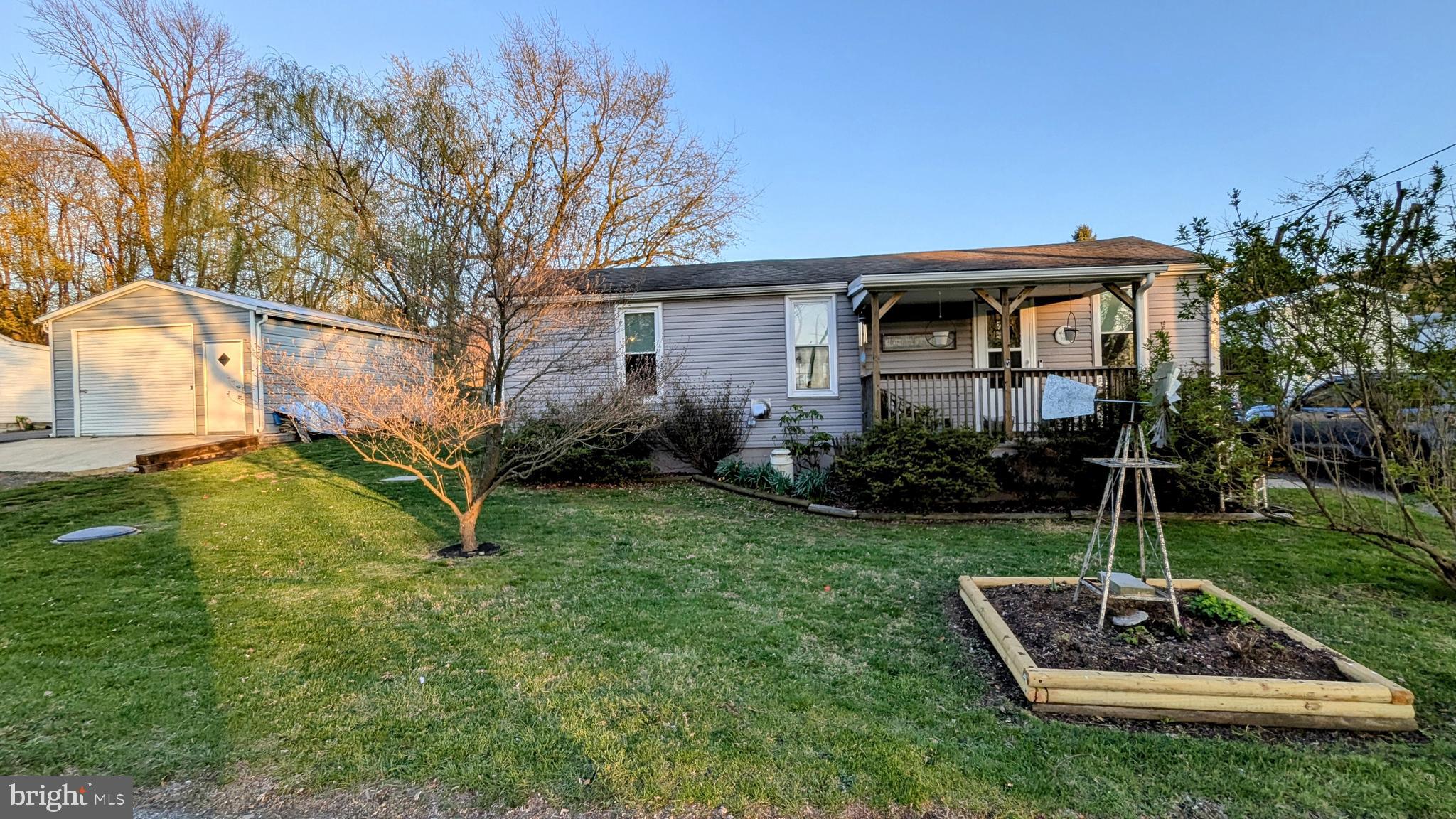 OPEN HOUSE this Sat. April 19  ** 1-3 PM ** Welcome Home ** This immaculate and fully updated rancher offers convenient first-floor living with 3 spacious bedrooms, 1 full bathroom, an office/den, and a cozy sitting room, all in excellent condition. The chef’s kitchen boasts hickory solid wood cabinets, quartz countertops, a sleek black and white backsplash, stainless steel appliances, a gas stove with hood range (propane), and plenty of prep and storage space. Additional interior features include luxury vinyl flooring, new carpet, fresh paint, a pellet stove, propane heat, a high-efficiency air filter, new washer and dryer, and new laundry cabinets for extra storage. The home is well-maintained with a roof from 2011, newer siding and gutters (2020), and newer windows. French doors bring in natural light and lead to a large, fully fenced backyard with mature landscaping—perfect for entertaining—featuring a firepit, large shed, Rubbermaid shed, and an oversized detached pole building with a wood stove, ideal for a workshop or hobby space. There's parking for up to 5 vehicles, a welcoming front porch, and a backyard entertainment area. Conveniently located near Ft. Ritchie Center and the lake, this home also offers public water and sewer, making it a truly move-in-ready gem.