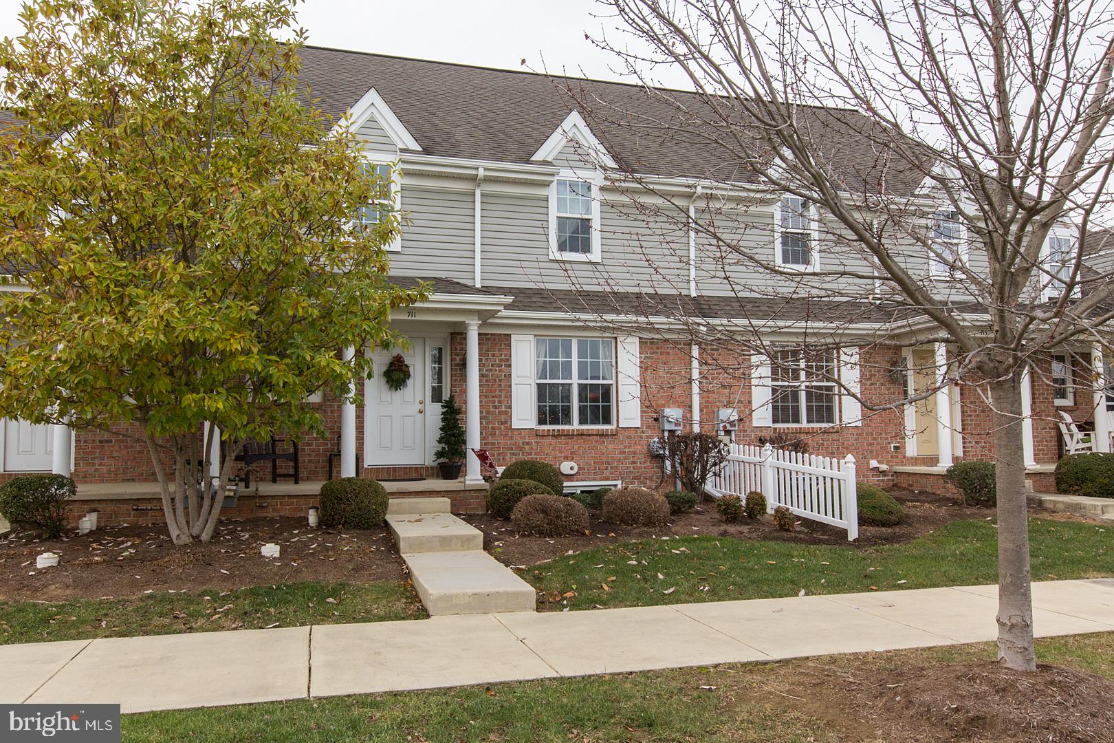 Fabulous townhome with one floor living! Open layout with 2 story Foyer and lots of natural light. FIRST floor bedroom with master bath that features double bowl sinks plus Laundry area. Hardwood Flooring in Dining Room and Foyer.  Two spacious bedrooms on 2nd floor with an additional 11x12 loft.  Loft could be great office space, exercise room or play area. Family Room in Finished Lower Level with separate office/den and tons of storage.  Cozy, quaint, private patio. Situated directly across from community pool, PERFECT for a quick dip during those hot summer days! Low maintenance and easy living. Wonderfully maintained and tastefully decorated. New hot water heater (natural gas), Reverse Osmosis system with filtered drinking water at kitchen, Water Softener, Economical natural gas heat plus central air.