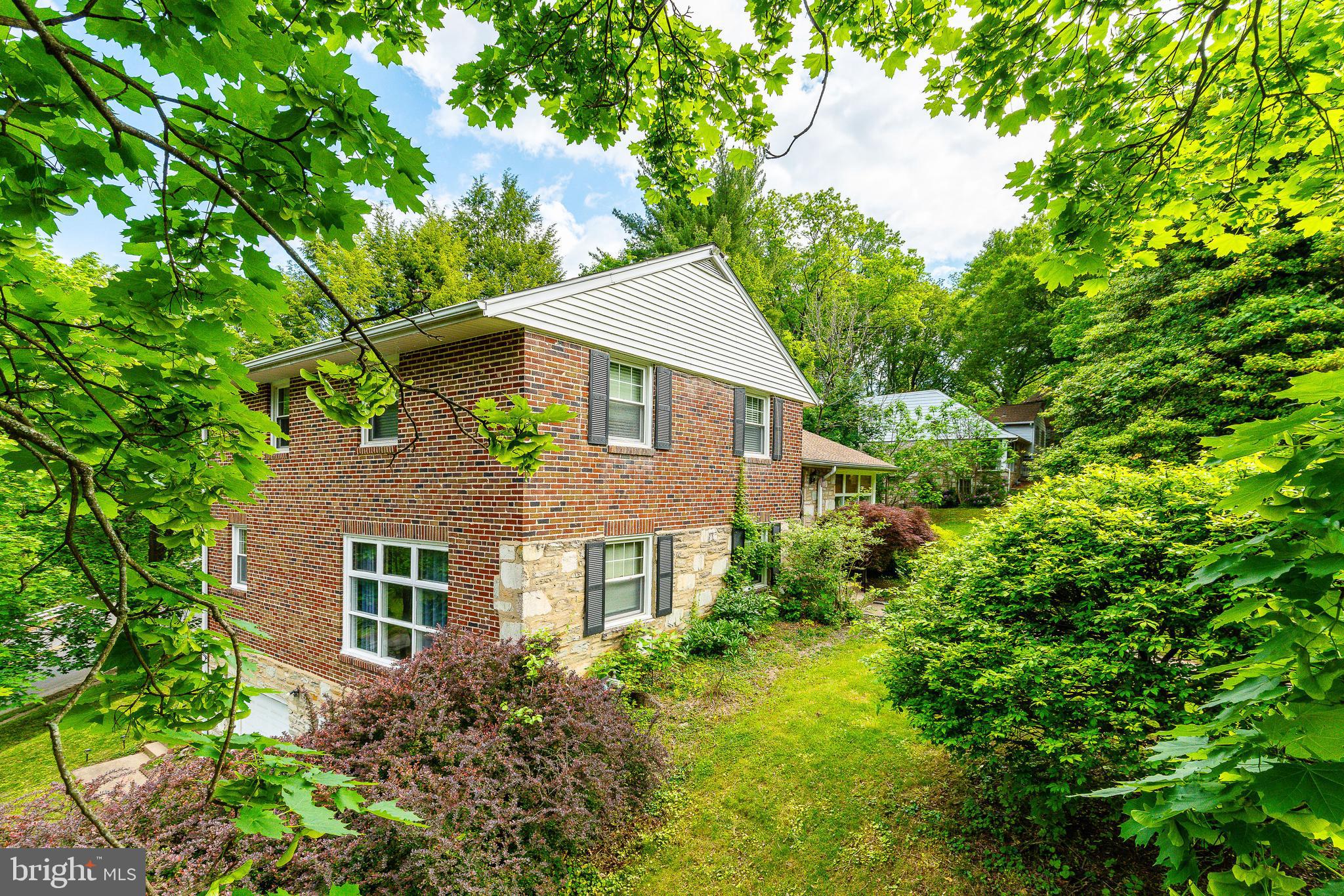 Welcome to 1128 Coventry Rd.! Sitting on a lush corner lot in sought-after Cheltenham, this home features beautiful hardwood floors, oversized windows, and tranquil views of surrounding tree life. Enter the open living area, which can comfortably hold a family room, office area, and dining space. Your bright kitchen is also on this level, where you'll enjoy updated appliances, and plenty of counter and cabinet space. The split level stairs take you to three large bedrooms (one with an en-suite bathroom). Also on this floor is a large bonus closet and bonus full bathroom. Downstairs from the first floor, find a sunny living room with a fireplace, additional half bath, and lots natural light from the extra windows. Exit to your stone patio, which is perfect for entertaining, relaxing, or grilling. The basement is one level further down. Here is laundry, lots of storage, and a convenient slop sink. From here, step into your massive 2 car garage. This home is walkable to Cheltenham Elementary, and less than a mile from a Regional Rail stop for quick Center City access. Also nearby are grocery stores (including two H-Marts), countless shops and restaurants, and multiple parks. This home is ready for its new owner - we can't wait to have you come by!